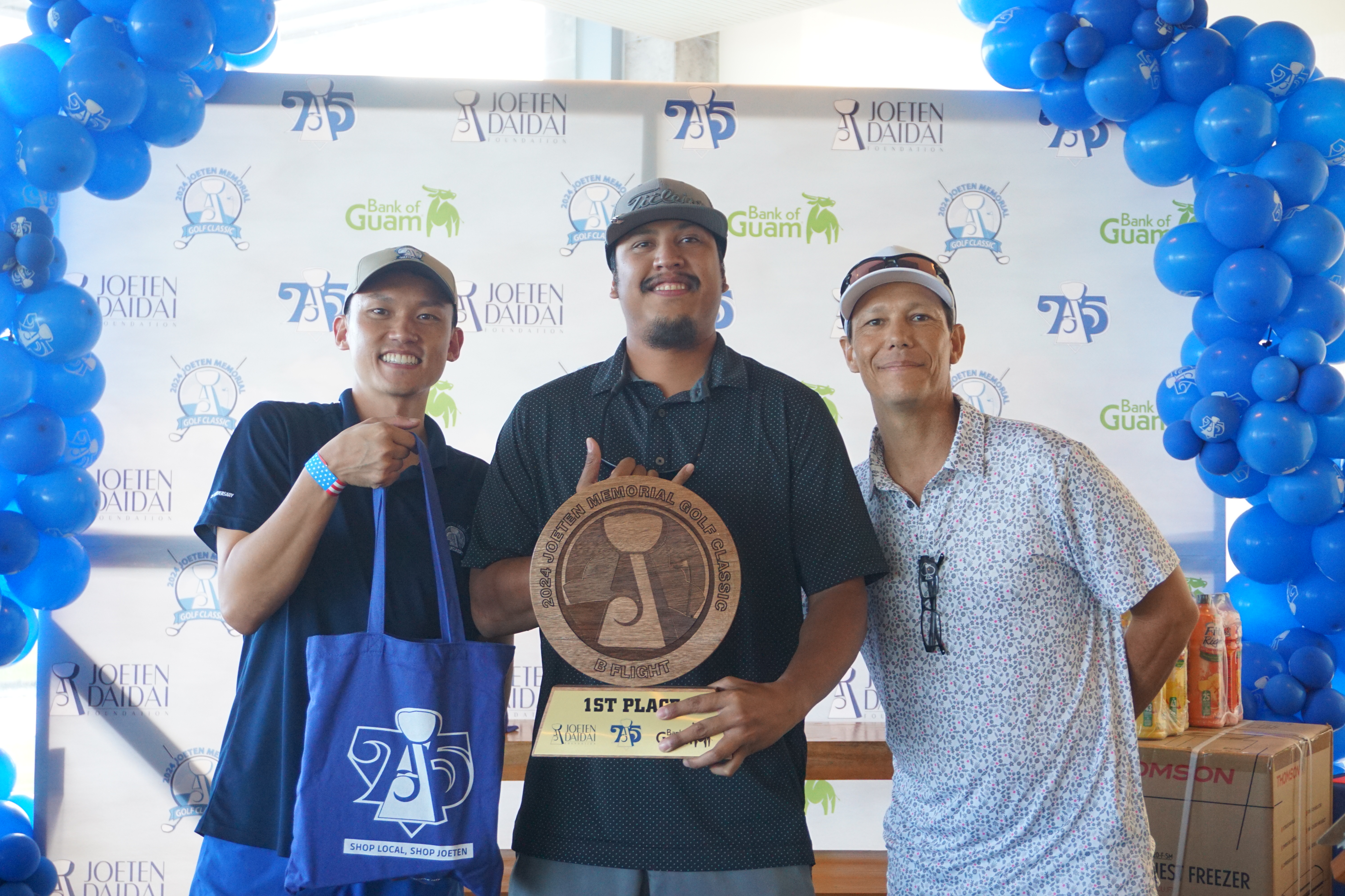 Keith Kintol, center, displays the B Flight trophy as he poses for a photo with Committee Chair Shigeki Tenorio, left, and Tournament Director Peter "Dung" Tenorio during the awards ceremony of the 2024 Joeten Memorial Classic at Laolao Bay Golf & Resort on Saturday.