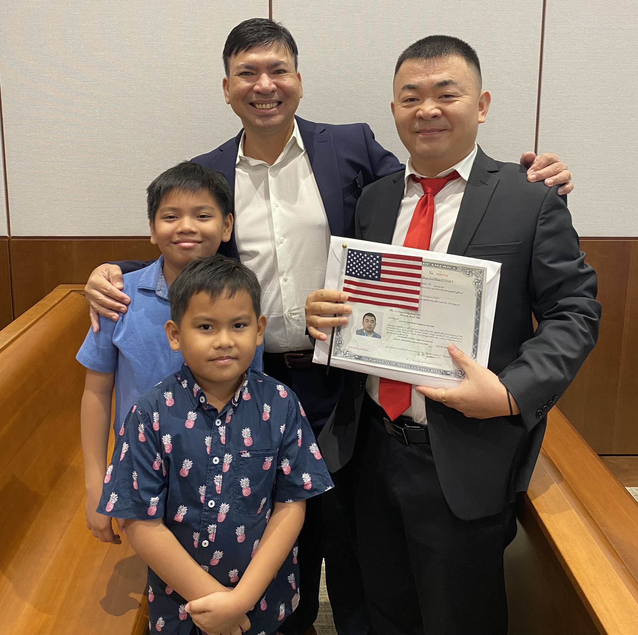 William Arago Abu, right, with husband Wilfredo Arago Abu and their two sons.