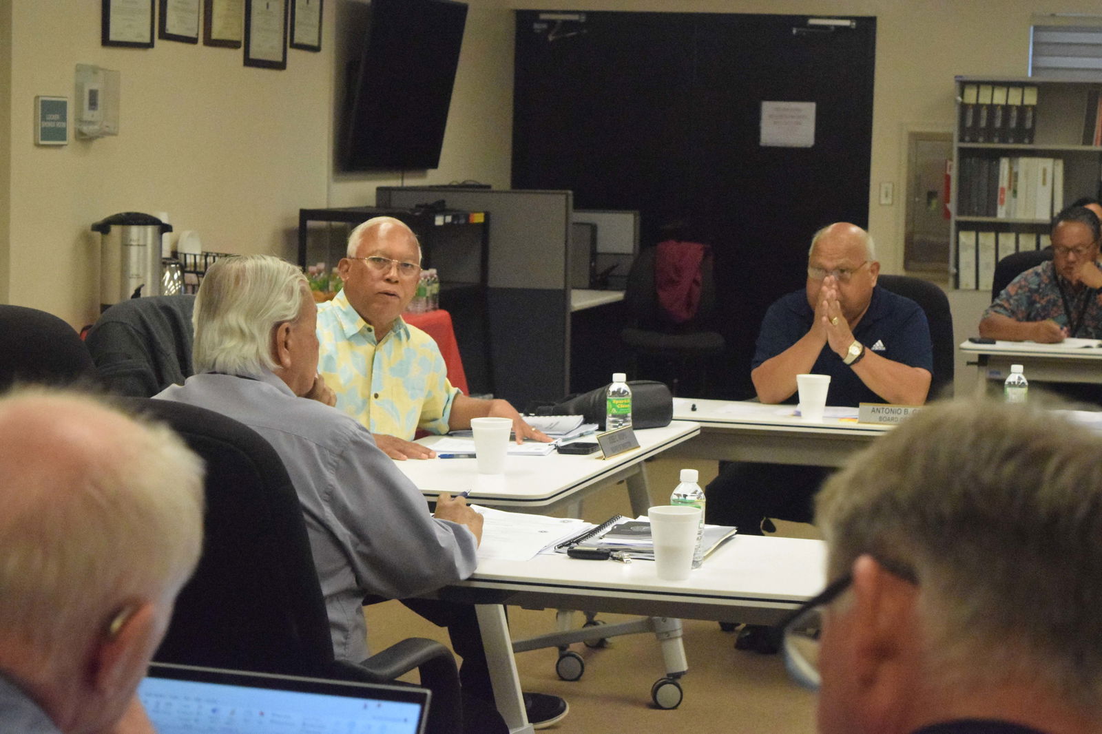 Commonwealth Ports Authority Board Chair Jose C. Ayuyu, third left, speaks as CPA Executive Director Leo B. Tudela, second left, back to the camera, and Board Vice Chairman Antonio Cabrera, second right, listen during a board meeting in the Aircraft Rescue and Firefighting classroom at the Francisco C. Ada/Saipan International Airport on Friday.