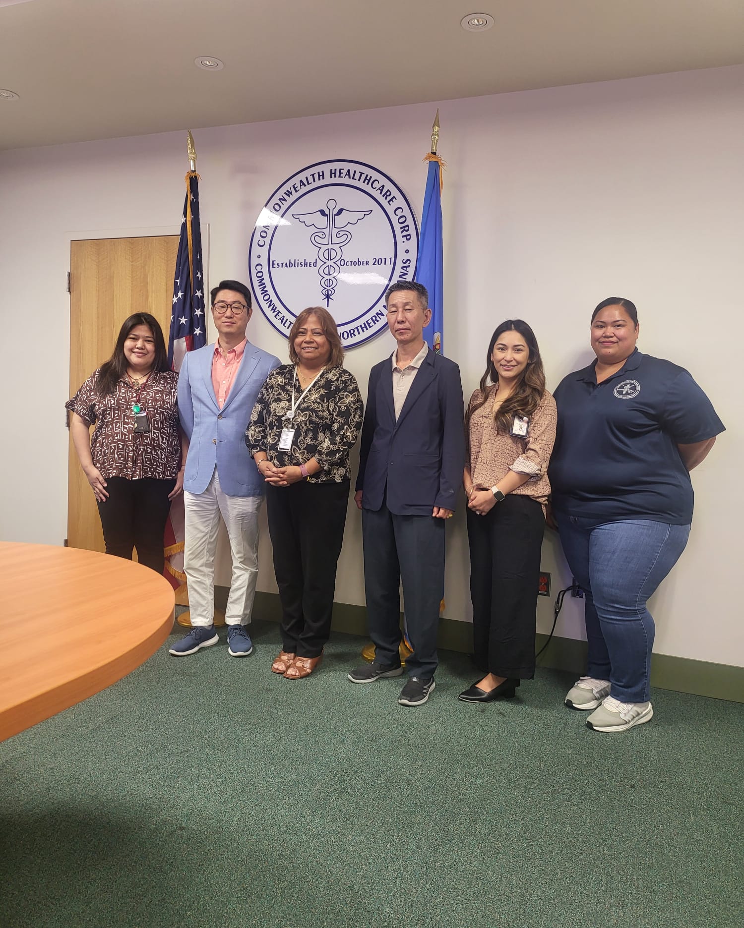 Commonwealth Healthcare Corp. Chief Executive Officer Esther L. Muna, third left, Chief Financial Officer Perlita Santos, left, and CHCC staff pose with Kang Dong Orthopedic Hospital Vice President Sharky Kang, second left, and International Healthcare Director Shon Park, third right.