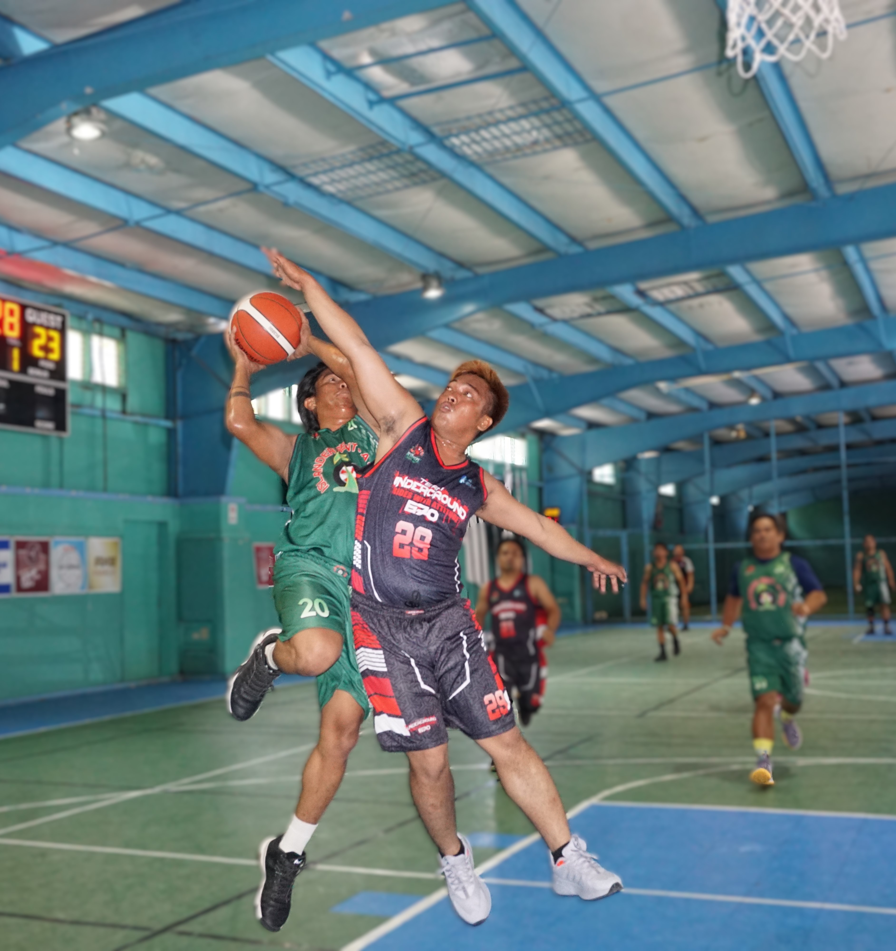 Island Rent A Car's Jose Broncano gets fouled as he goes up for the shot during an opening game of the Destroyers Basketball Club Invitational Basketball League at the TSL Sports Complex on Sunday.