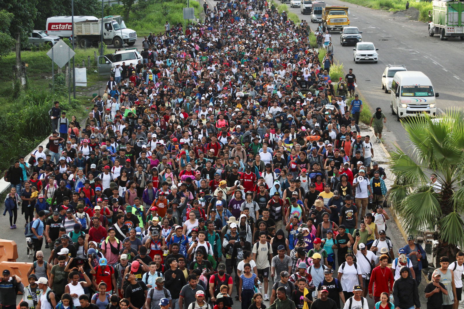 Migrants of different nationalities walk along a road in a caravan toward the U.S., in Tapachula, Chiapas state, Mexico July 23, 2024. 
