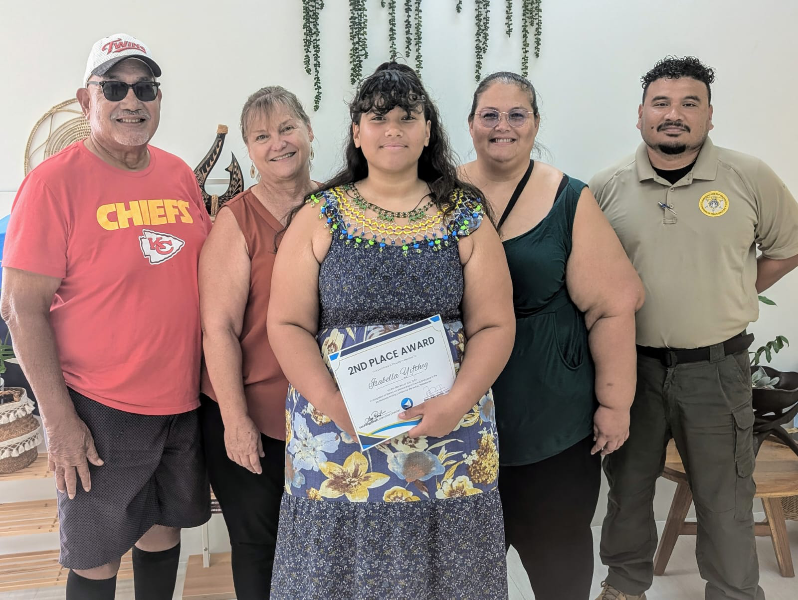 Isabella Yiftheg, center, poses with her family members after placing second in the My Marianas Writing Contest. The other student winners are Jhaylin Cruz and Stephanie Diaz. 