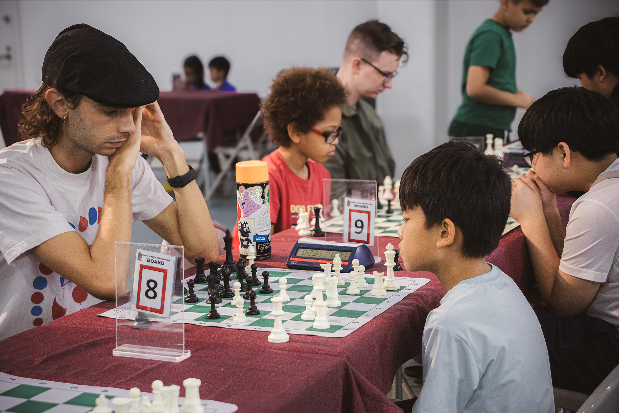 An adult and child play a game of chess during one of Guam Chess Federation's tournaments at the Micronesia Mall.