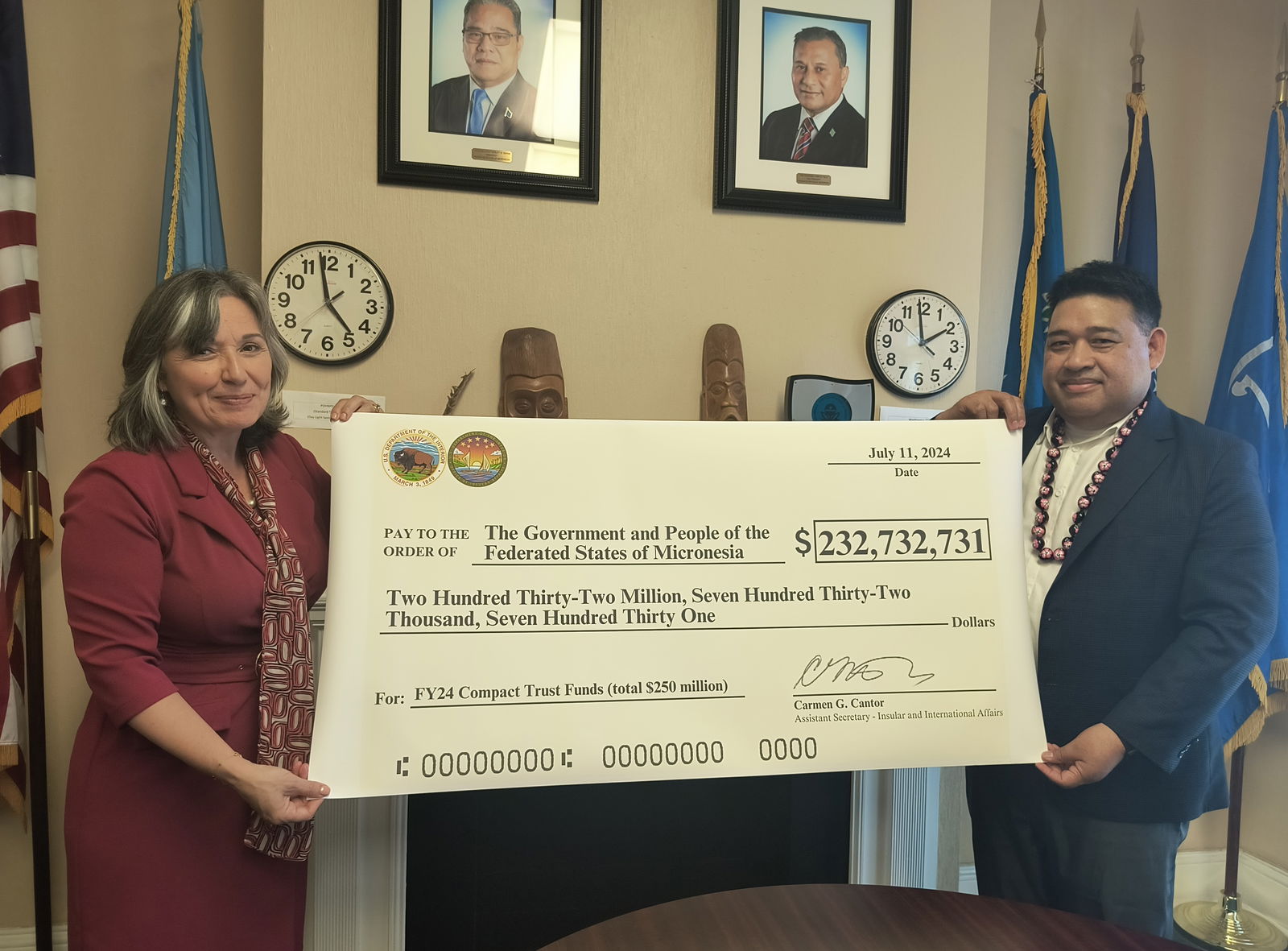 Interior’s Assistant Secretary for Insular and International Affairs Carmen G. Cantor and Federated States of Micronesia Ambassador Jackson Soram hold a check for over $232 million.