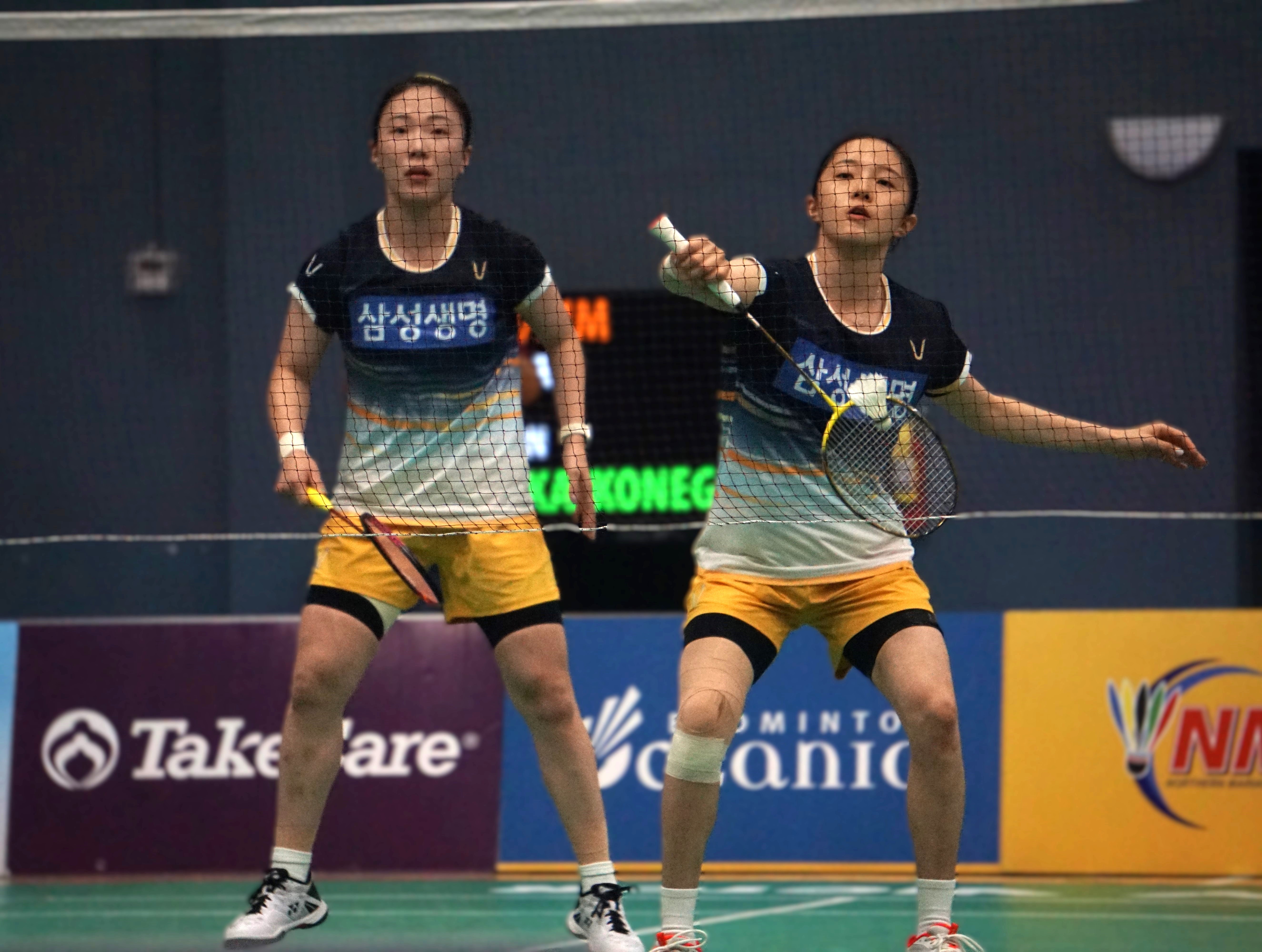 Korea's Hya Jeong Kim connects the back-hand return as teammate Yu Jung Kim looks on during the women's doubles finals match of the Dove Saipan International 2024 at the Ada gym on Saturday.
