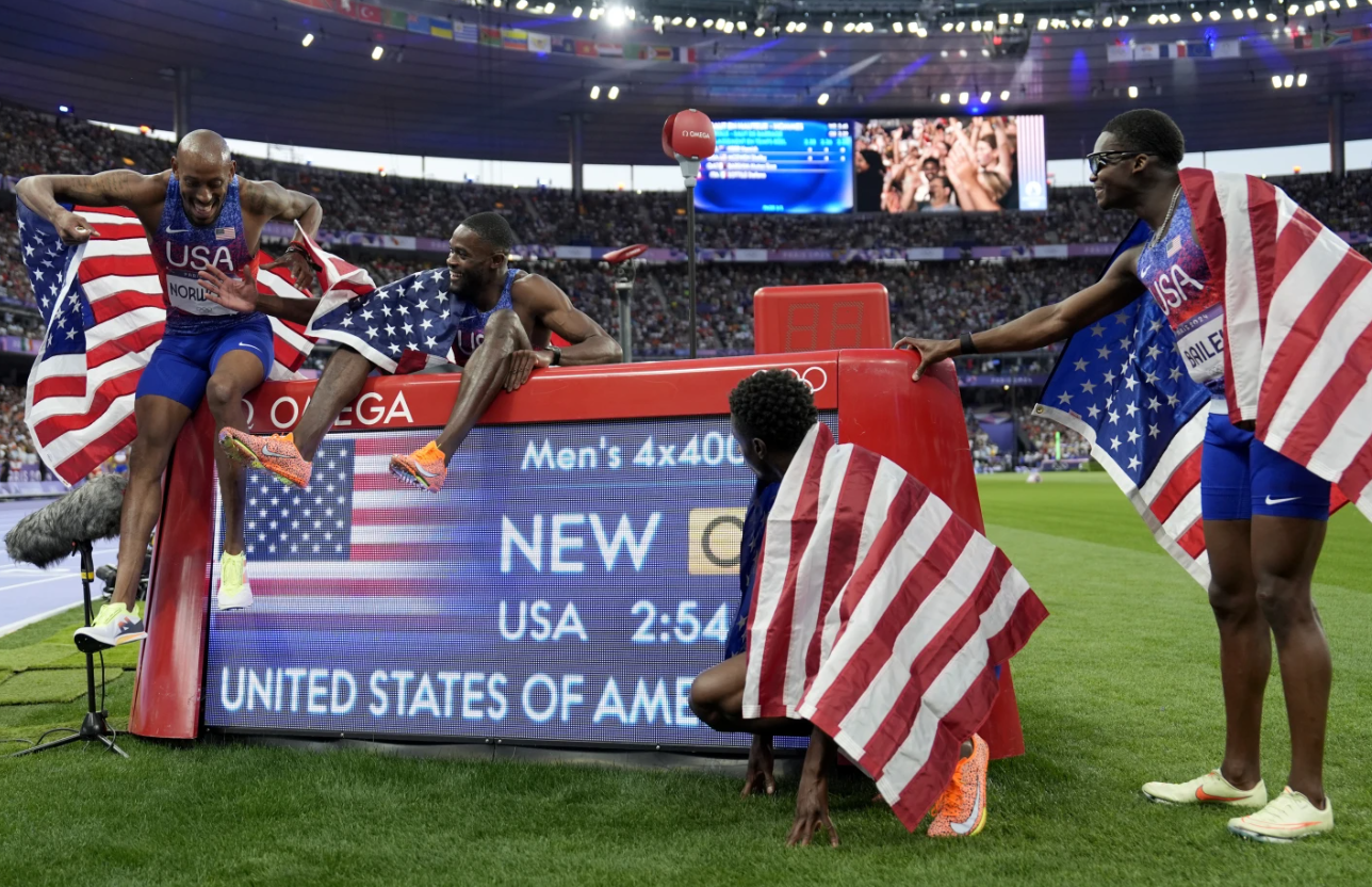 The U.S. men’s 4x400-meter relay team celebrates round the race clock after winning the final at the 2024 Summer Olympics, Saturday, Aug. 10, in Saint-Denis, France.