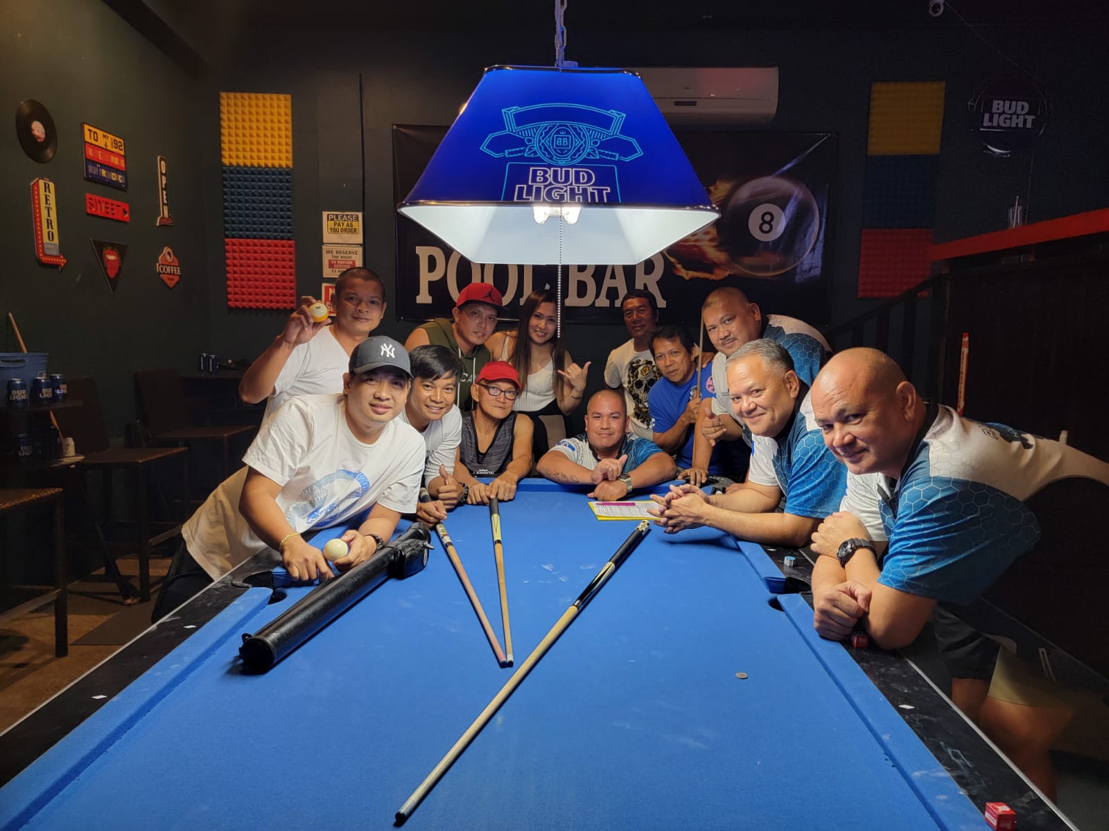 The Last Shot 8 Ball Shooters and the Black 8 Rack N' Roll players pose for a photo after their game in the Tuesday division of the SBA Budweiser Open 8-Ball League 2024 at Black 8 Pool Bar.