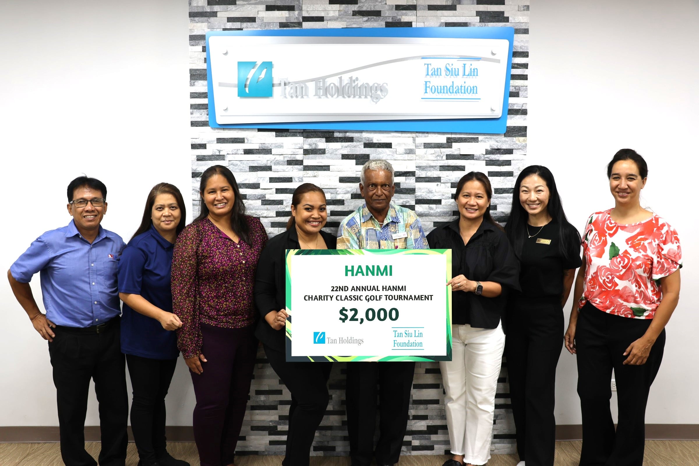 Tan Siu Lin Foundation Executive Director Merlie Tolentino, third right, turns over a $2,000 donation to tournament chairman Das Krishnan, fourth right, for the 22nd Annual HANMI Charity Classic Golf Tournament on July 31, 2024, at the JP Center in Garapan, Saipan.  Pictured from left are tournament committee member William Retardo, TSL Foundation Administrative Assistant Rina Robles, Tan Holdings VP for Community Relations Catherine Attao, and tournament committee members Julie Litulumar, Victoria Lee and Catherine Perry.