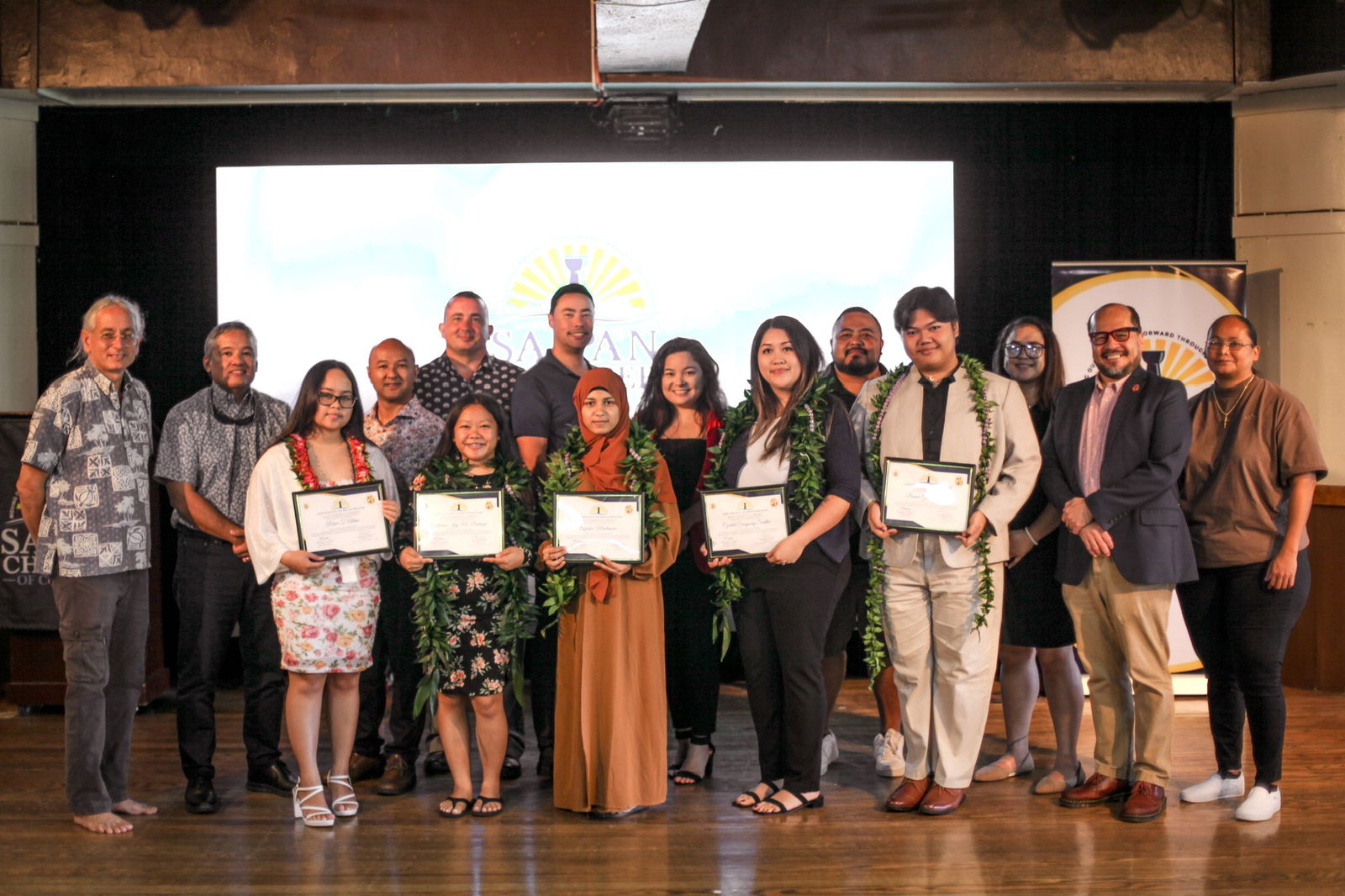 From left, Saipan Chamber of Commerce Board Secretary Ron Smith, SCC Board Director Alex Sablan, SCC Scholarship Recipient, Reine  Aldan, SCC Board President Joe Guerrero, SCC Scholarship Recipient Catherine Barozzo, SCC Board Director Brad Ruszala, SCC Vice President Joshua Wise, SCC Scholarship Recipient Ayesha Mustansar, SCC EdWork Committee Chair, Mercilynn Palec, SCC Scholarship Recipient Crystal Seidler, SCC EdWork Committee Member, Benjamin Babauta, SCC Scholarship Recipient Bonnie Gio Sagana, SCC EdWork Committee Member, Plumeria Castro-Aldan, Northern Marianas College President, Galvin Deleon Guerrero, and Northern Marianas Technical Institute Chief Executive Officer, Jodina Attao.