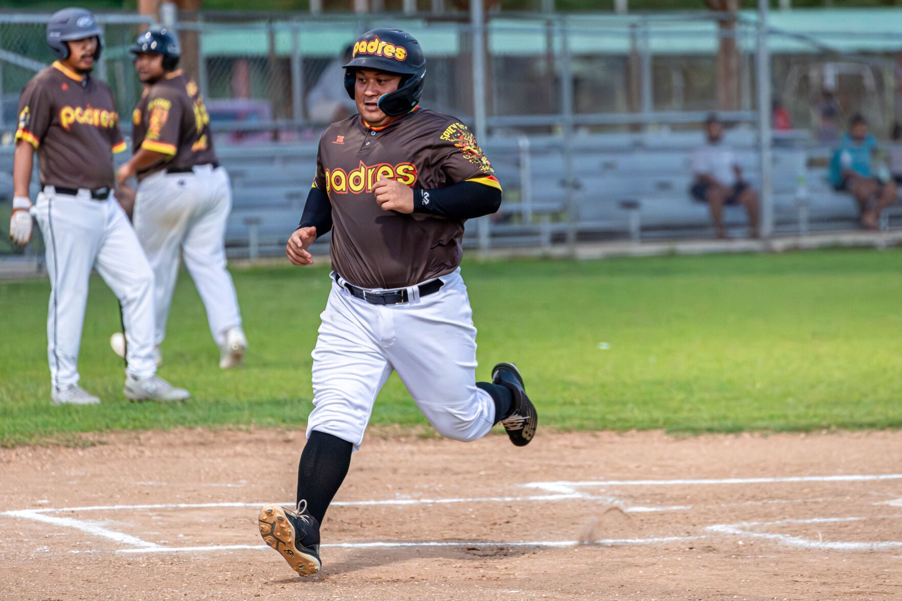 The Padres' JP "The Sledgehammer" Sablan makes his way past the home plate for a scored run during a game in the 2024 Tan Holdings Saipan Baseball League at the Francisco "Tan Ko" Palacios baseball field.