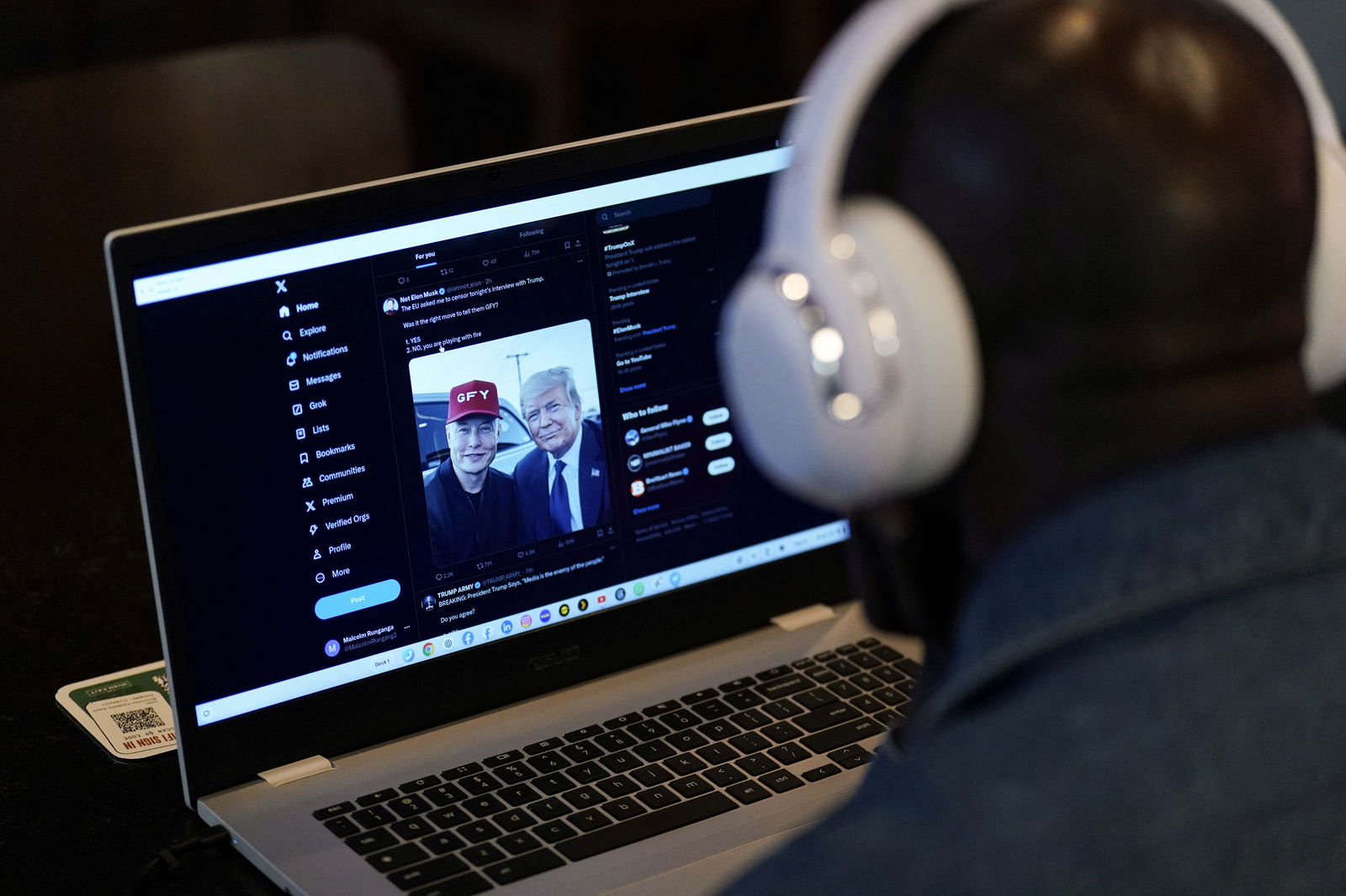 A person tries to watch on a laptop billionaire entrepreneur Elon Musk's interview with Republican presidential candidate Donald Trump on the X social media network, in New York City, Aug. 12, 2024.