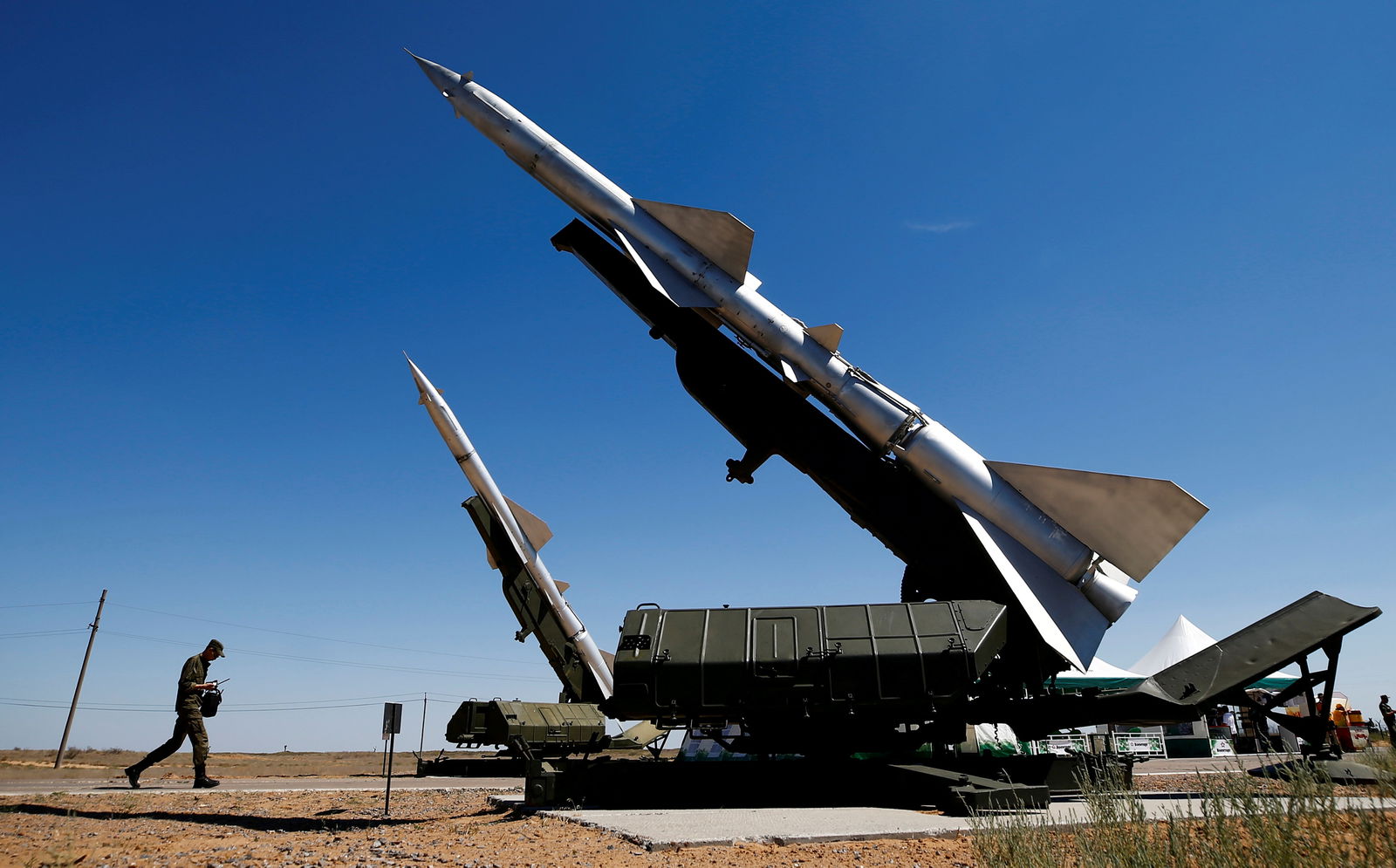 A serviceman walks past anti-aircraft defense mobile missile systems during the Keys to the Sky competition at the International Army Games 2017 at the Ashuluk shooting range outside Astrakhan, Russia, Aug. 5, 2017.