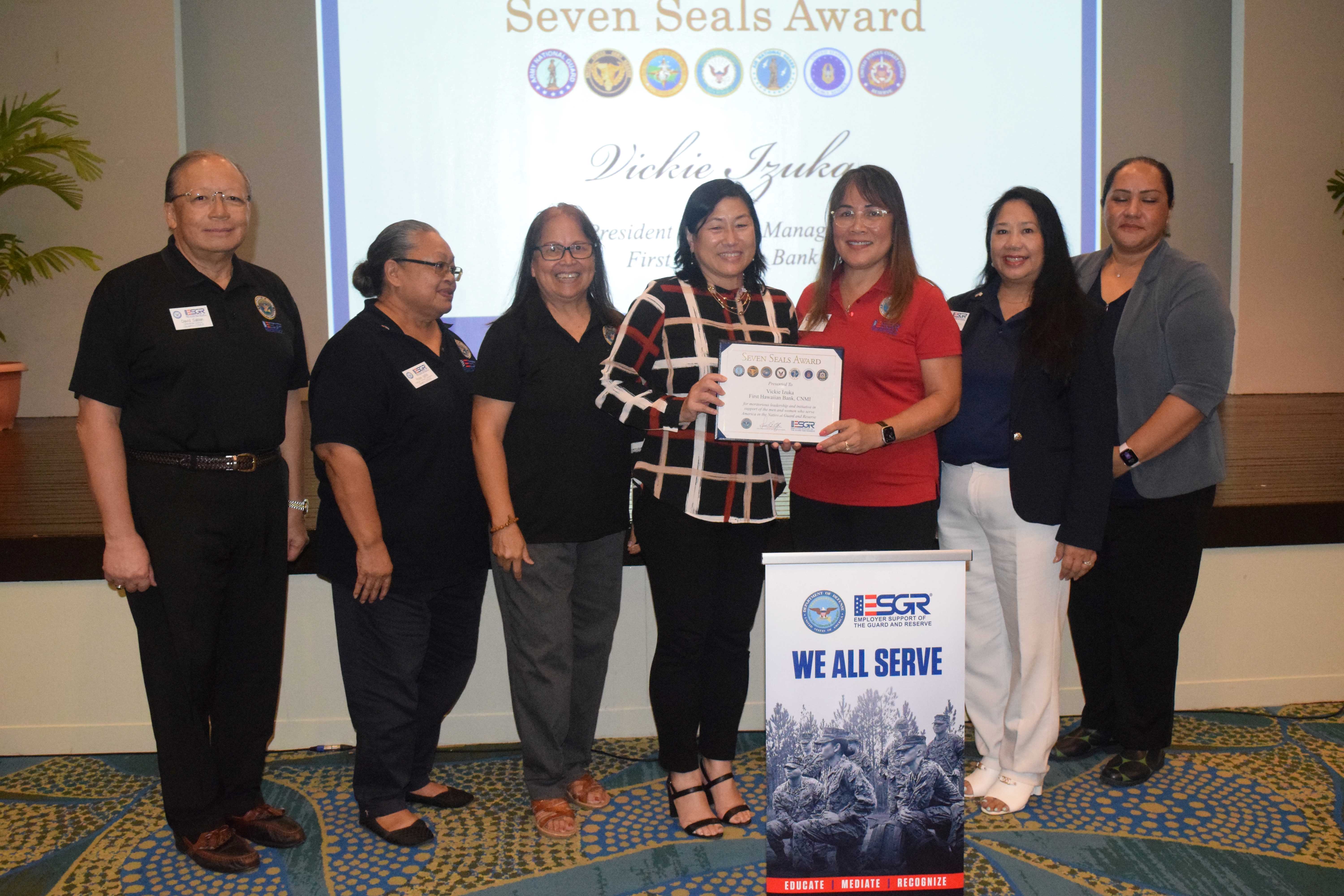 First Hawaiian Bank NMI Vice President and Branch Manager Vickie Izuka, center, receives the Patriot Award from ESGR Guam-CNMI State Chair Cathy Gogue. Also in photo are Ombudsman Director Dave Sablan Jr., Employer Outreach Coordinator Rose Igitol, Area Chair Dr. Rita A. Sablan, Ombudsman Joann Aquino, and volunteer Tanya David.