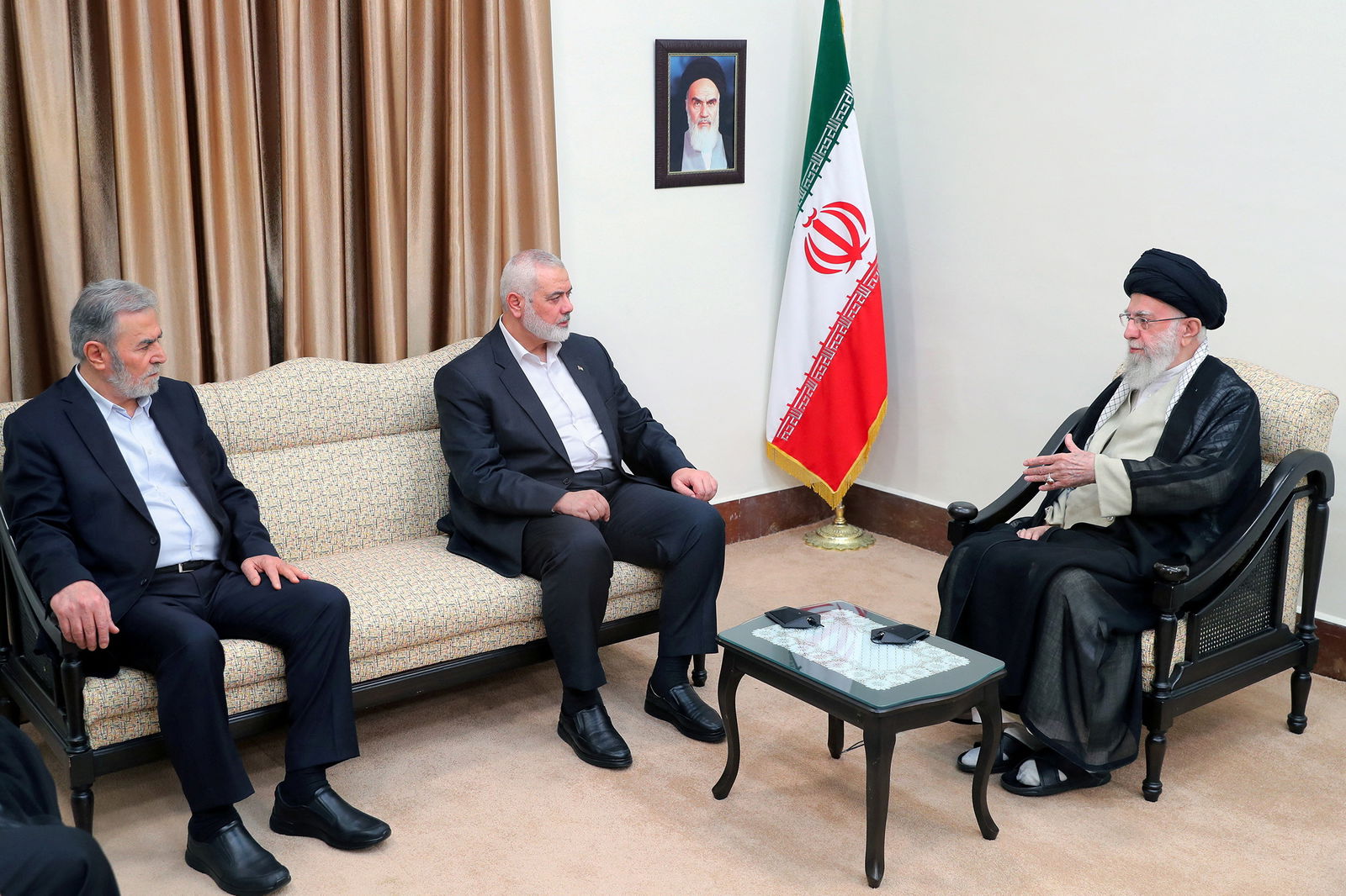 Iran's Supreme Leader Ayatollah Ali Khamenei, right, meets with Palestinian group Hamas' top leader Ismail Haniyeh, center, and Palestinian Islamic Jihad chief Ziad al-Nakhala in Tehran, Iran July 30, 2024.
