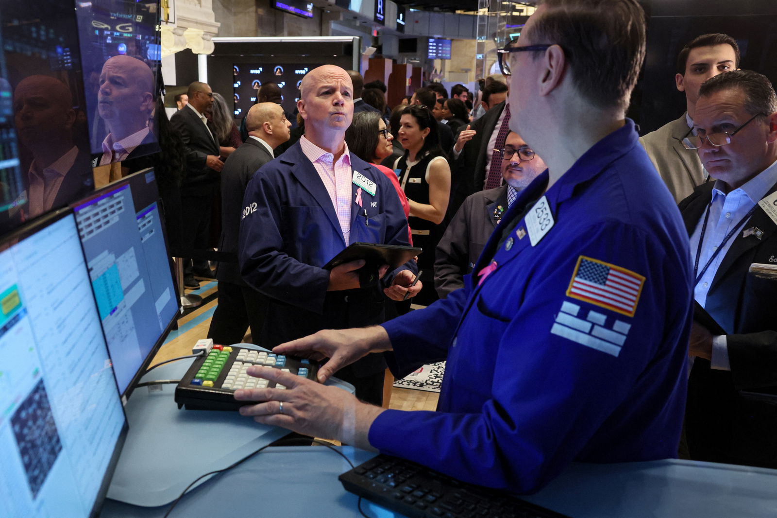 Traders work on the floor at the New York Stock Exchange in New York City, June 14, 2024.