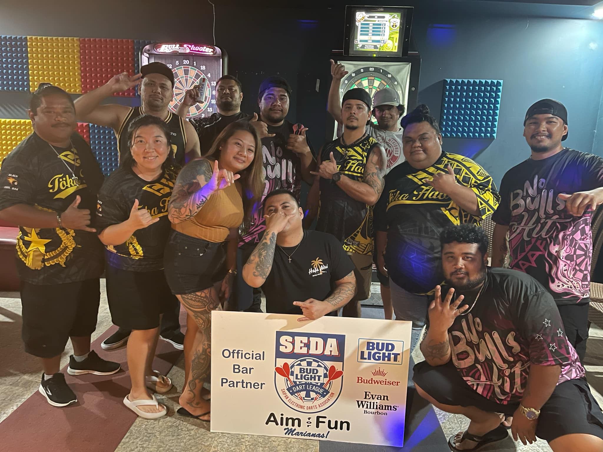The players of Bravo No Bulls Hit and Black 8 Toka Hao pose for a photo after their match in the Kingfisher C division of the 2024 SEDA Bud Light Dart League at the Black 8 Pool Bar.