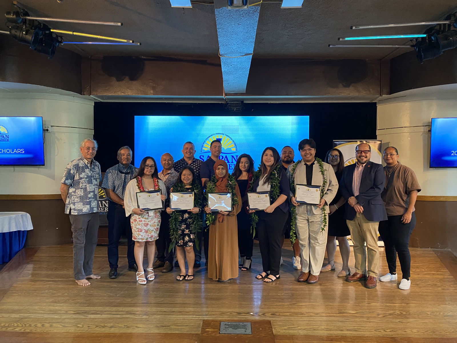 This year’s scholarship recipients pose for a photo with Saipan Chamber of Commerce officers and educators at the Pacific Islands Club on Wednesday, Aug. 7, 2024.