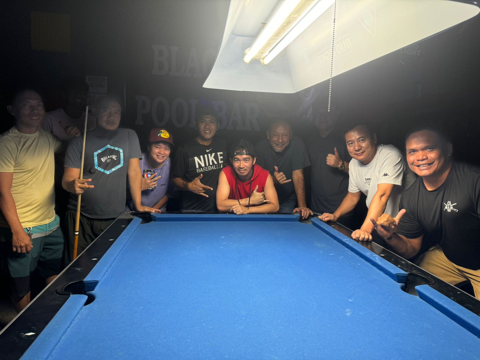 The Last Shot Fighters and Black 8 Crooked Arrow pose for a photo after their Tuesday division match in the 2024 SBA Budweiser Open 8-Ball League at the Black 8 Pool Bar.