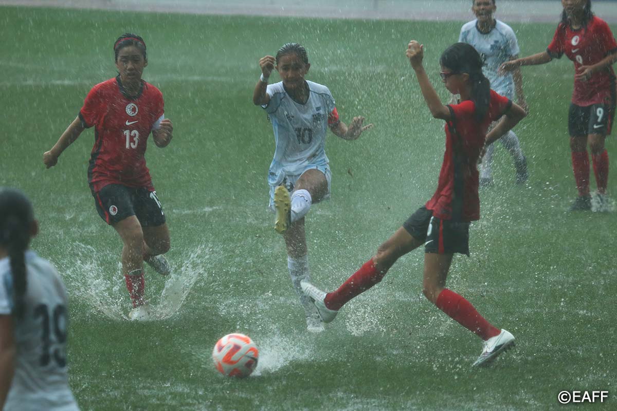 The NMI Women's U15 National Team's Beatrice Gross slips a pass between two defenders during a game against Hong Kong in the East Asian Football Confederation U15 Women’s Championship 2024 at the Dalian Football Youth Training Center in China on Tuesday.