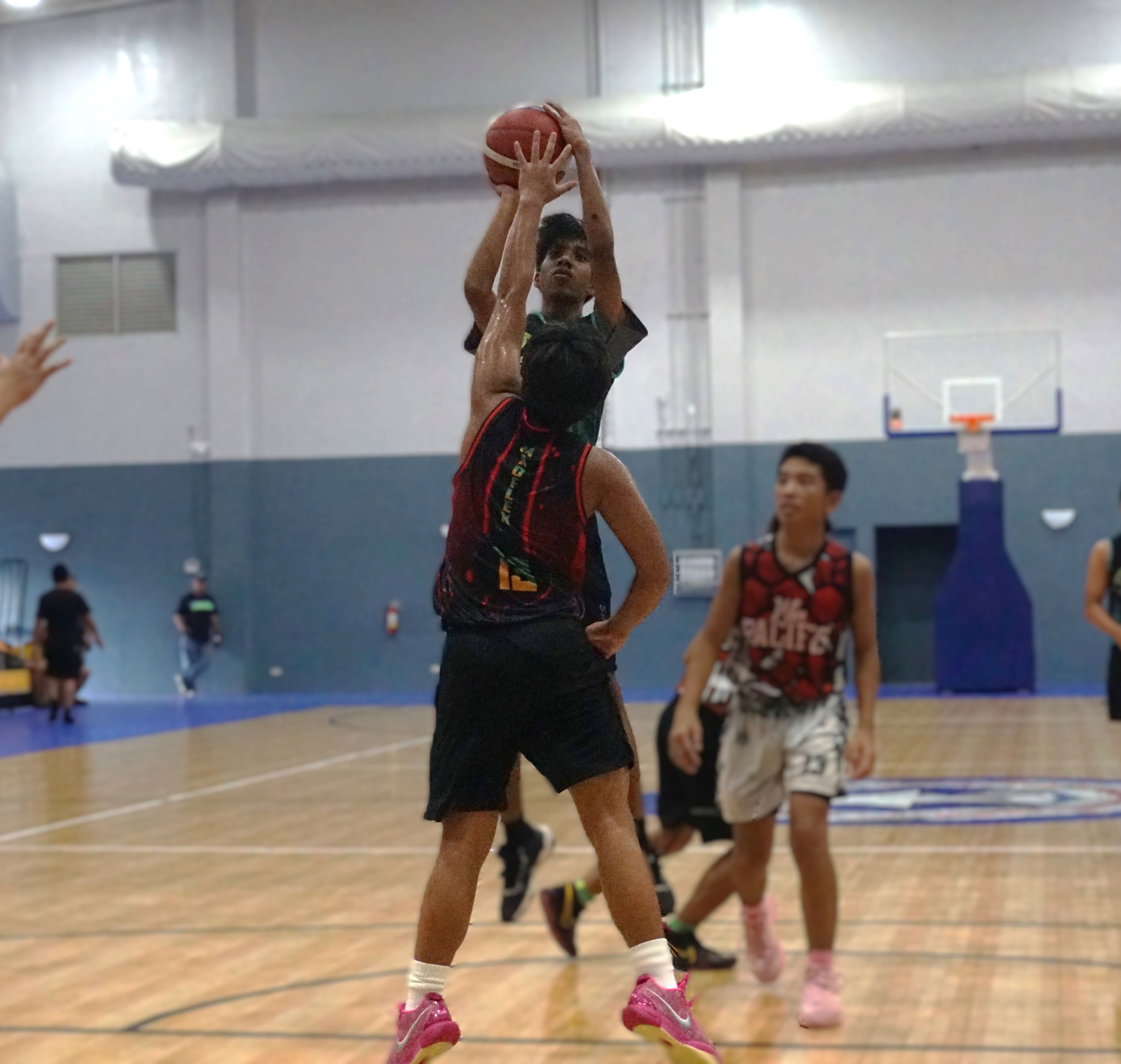 Hardt Eye Clinic's Letrell Pelisamen takes the mid-range jump shot over a defender during a game against Win Pacific Corp in the Ali’i Madflex Sports Summer Youth Basketball Tournament 2024 at the Ada gym on Saturday.