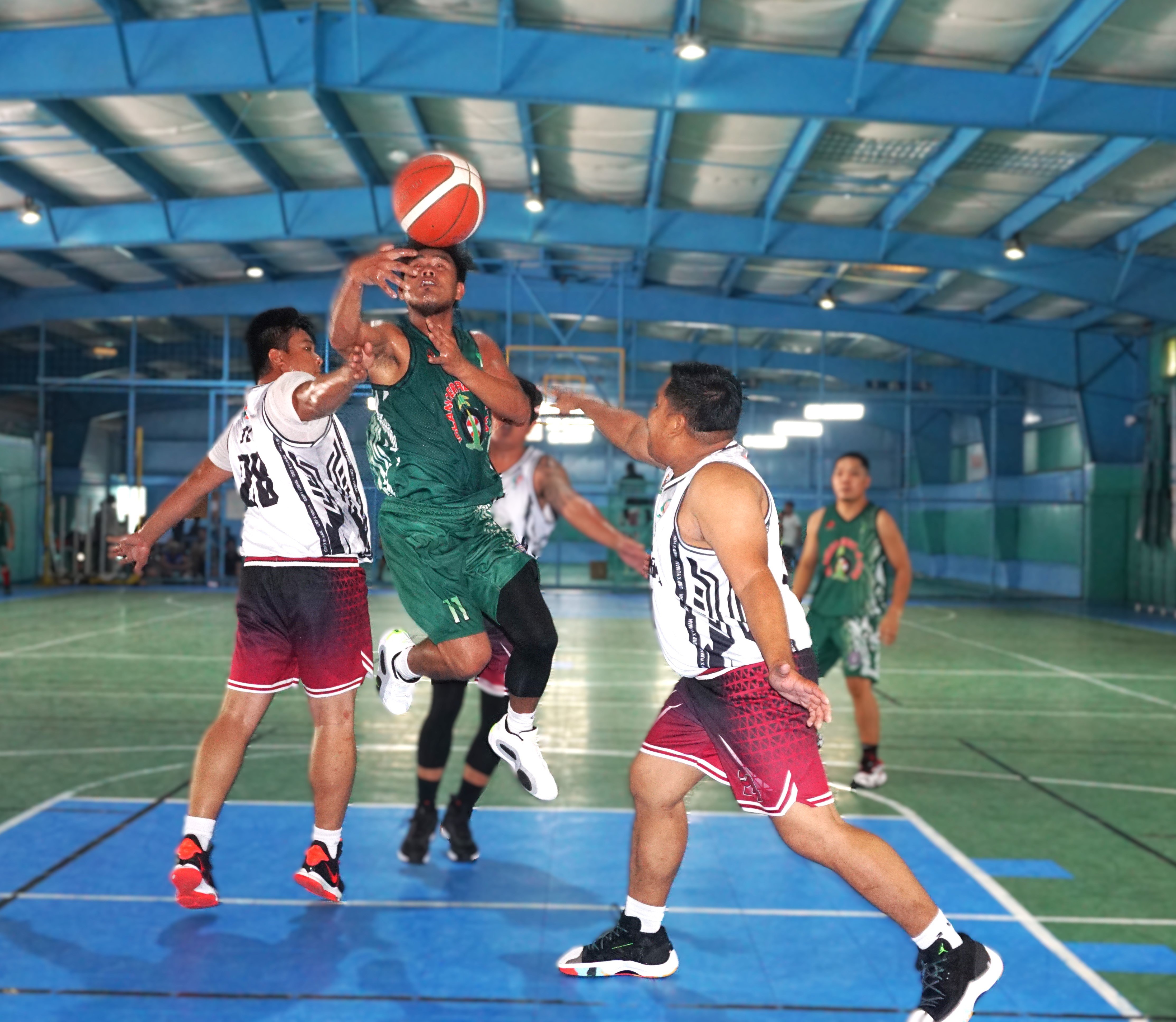 Islander Rent-A-Car's Frank Ferrer gets fouled as he goes up for a layup during a game against GMP x Yuman in the Destroyers Basketball Club Invitational Basketball League 2024 at the TSL Sports Complex on Sunday.
