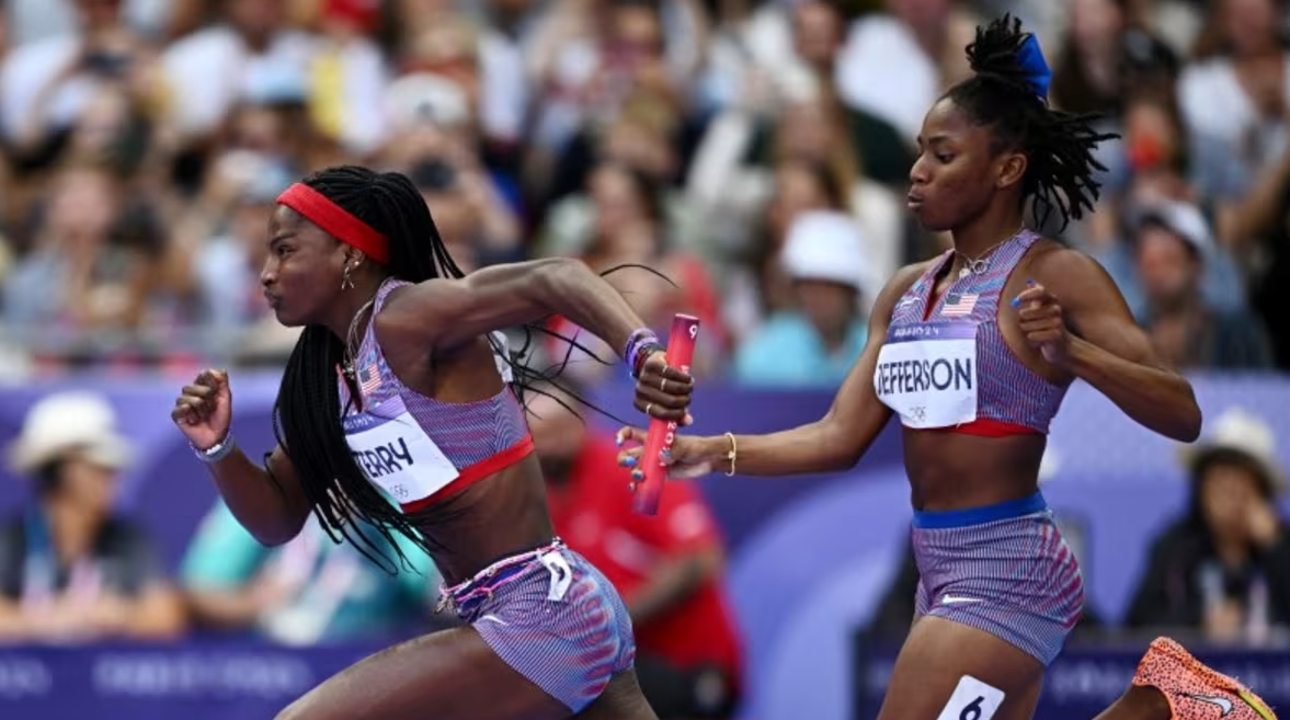 Twanisha Terry in action with fellow American Melissa Jefferson during heat 1 of women's 4x100m relay at the Stade de France in Saint-Denis, France on Aug. 8, 2024.