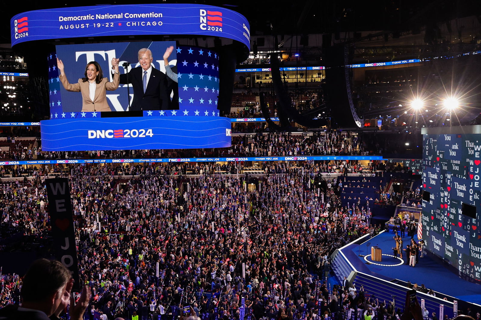 Democratic presidential candidate Kamala Harris and President Joe Biden raise their arms on stage during Day one of the Democratic National Convention in Chicago, Illinois, Aug. 19, 2024.