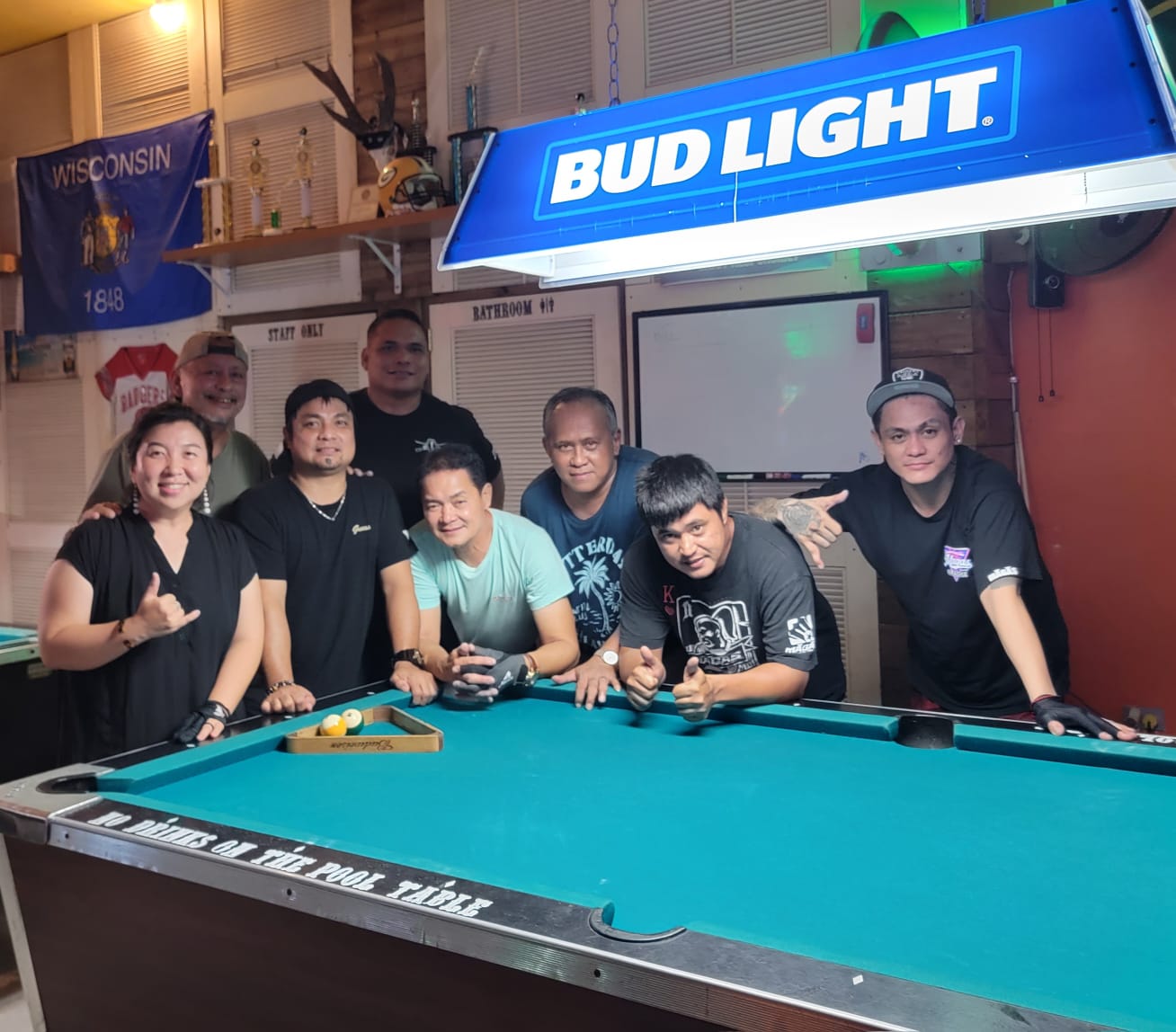 The Last Shot Raiders and Black 8 Crooked Arrow pose for a photo after the conclusion of their match in the Tuesday division of the SBA Budweiser Open 8-Ball League 2024 at the Last Shot Bar on Tuesday.