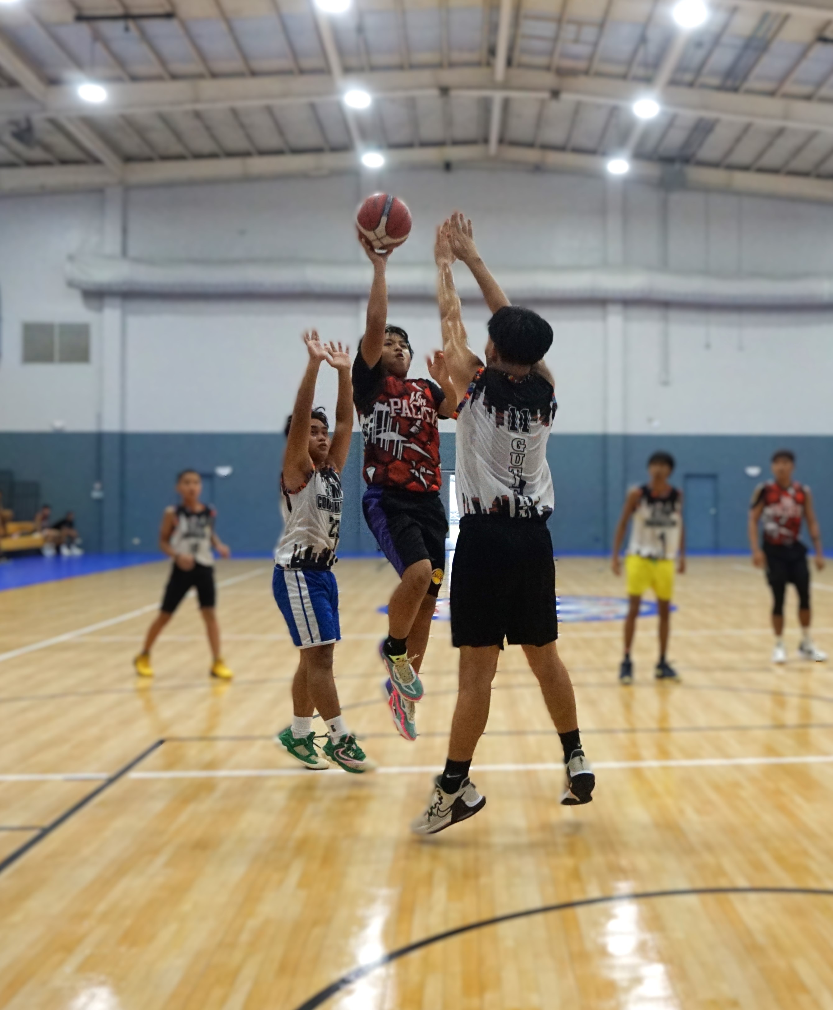 Win Pacific Corp's Louis Rectitud takes the floater against two defenders during a game against JTM Corp in season 1 of the Ali’i Madflex Sports Summer Youth Basketball Tournament 2024 at the Ada gym on Saturday.