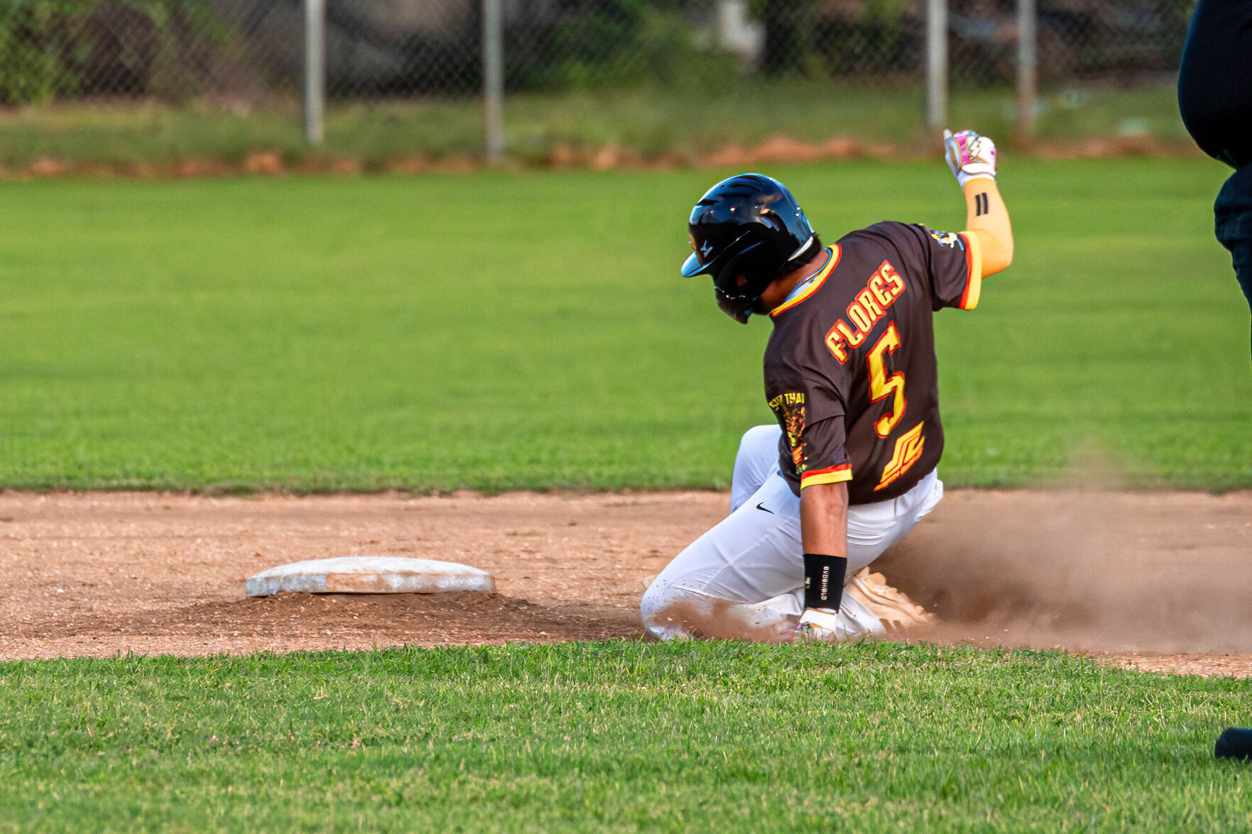 The Padres’ Jonah Flores slides to second base to beat a pick-off attempt during a game in the 2024 Tan Holdings Saipan Baseball League at the Francisco "Tan Ko" Palacios baseball field.
