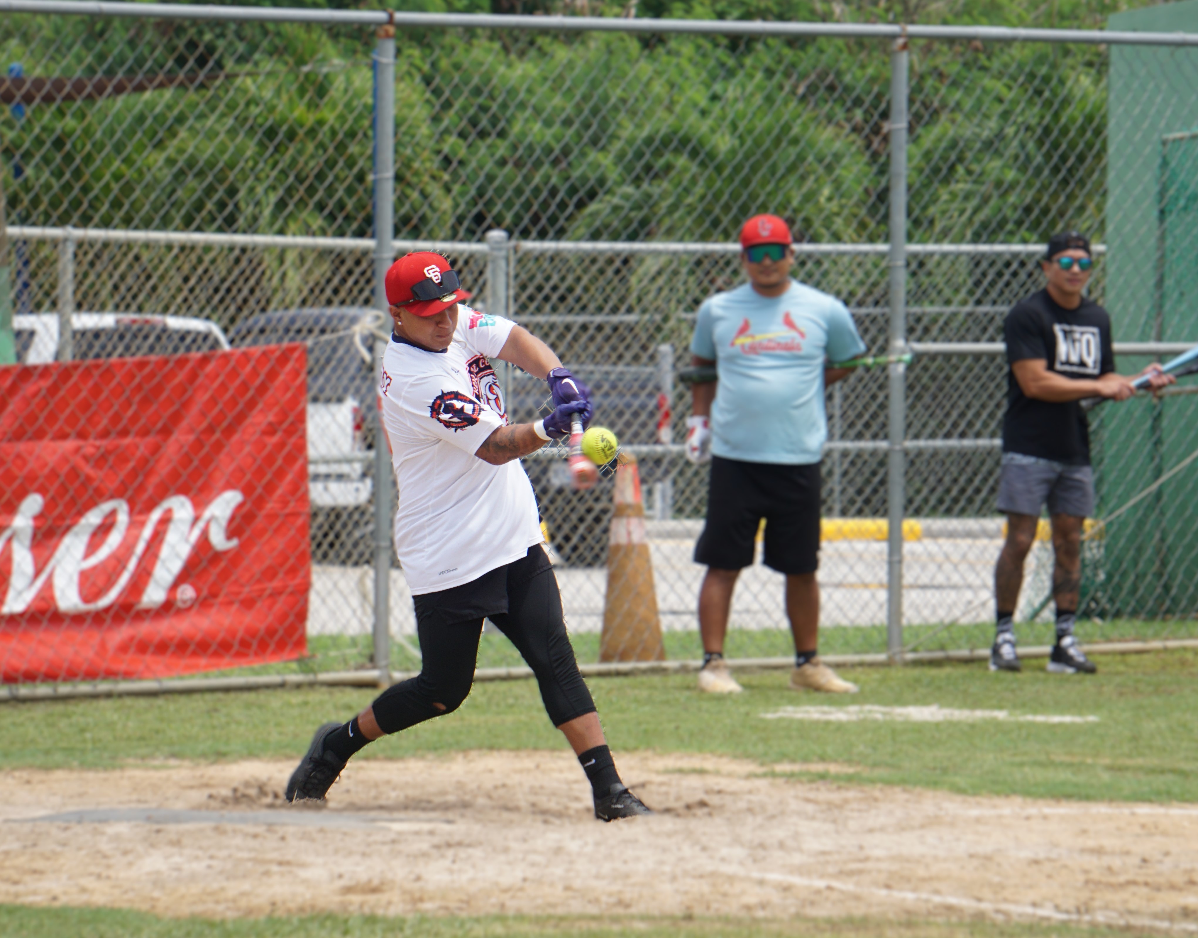 The Kliq's Josenio Alvarez connects a solo homerun during a game against Red Torch in the 2024 Budweiser Belau Amateur Softball Association Open League at the Dandan baseball field on Sunday.