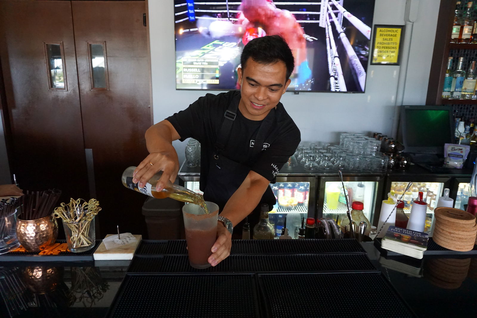 Nikko preps a michelada at Naked Fish. We think it would go amazingly with some oyster shooters. ​