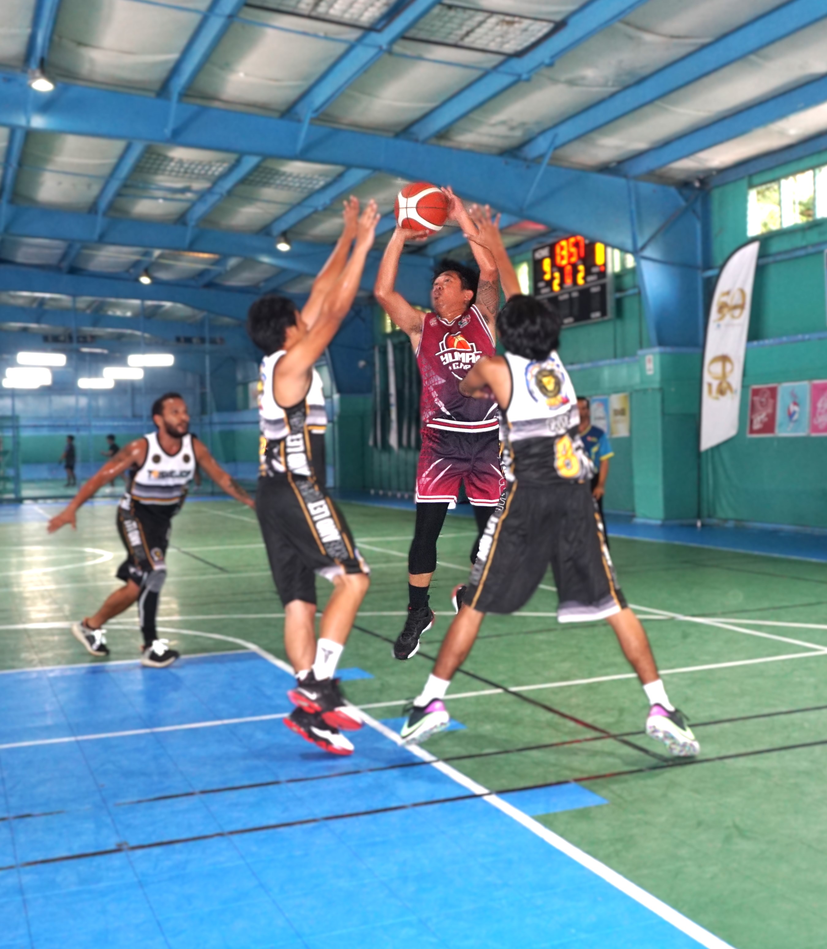 GMP x Yuman's Erick Nuyles takes a heavily contested shot over two defenders during a game against Triskelion in the Destroyers Basketball Club Invitational Basketball League 2024 at the TSL Sports Complex on Sunday.