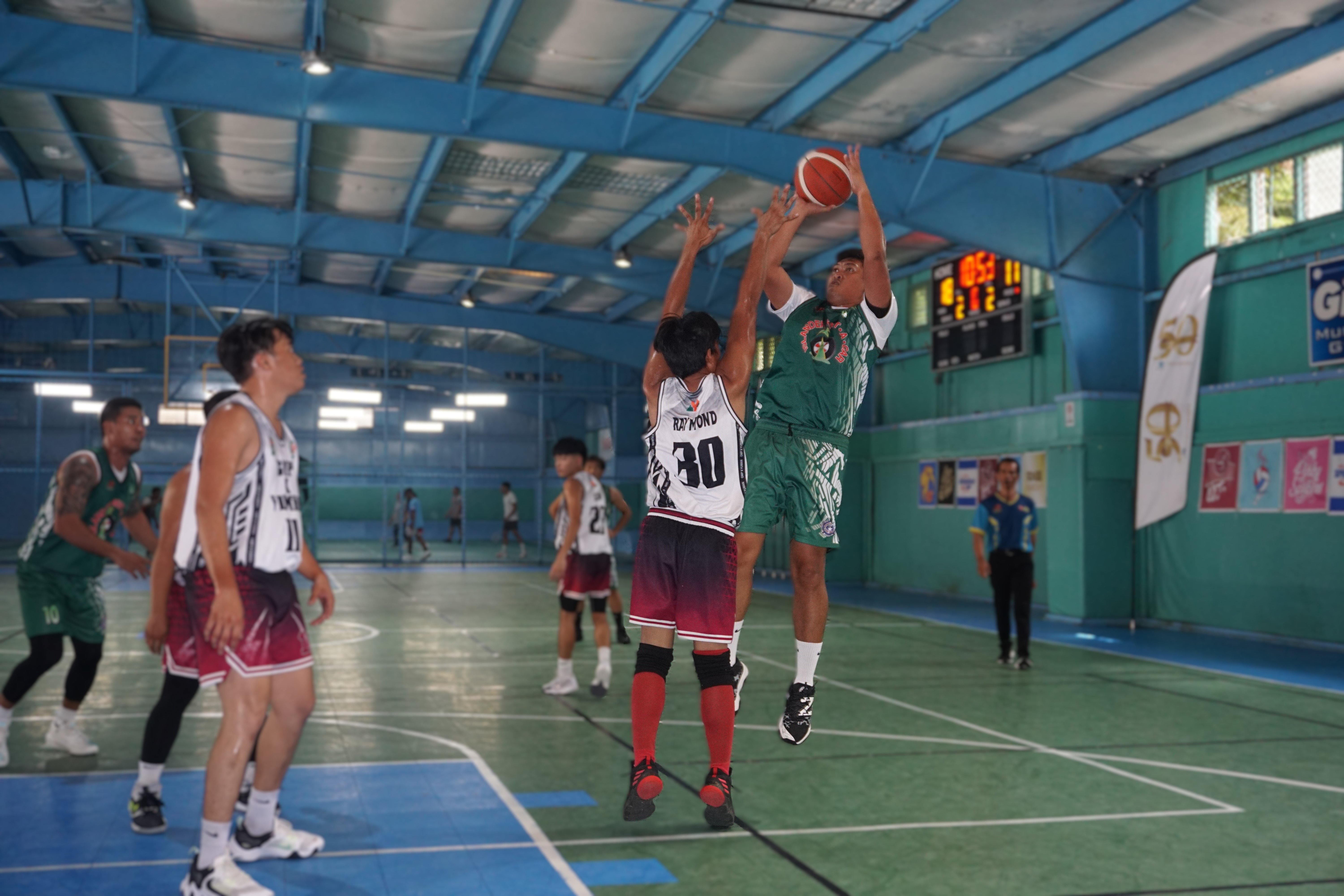 Islander Rent-A-Car's Nikko Mejarito takes the jump shot over a defender during a game against GMP x Yuman in the Destroyers Basketball Club Invitational Basketball League 2024 at the TSL Sports Complex on Sunday.