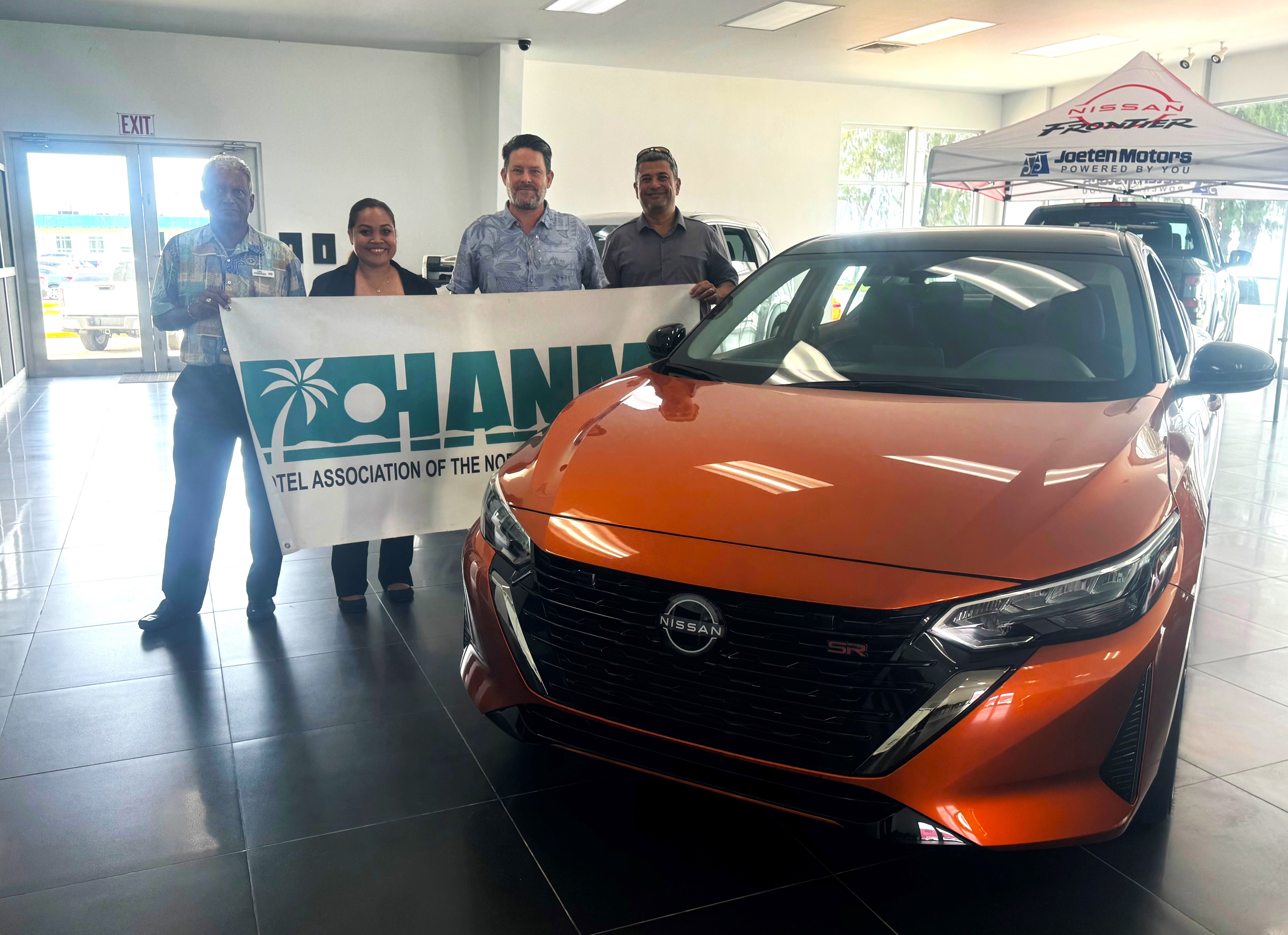 Joeten Motors General Manager Matthew Deets, 2nd right, presents a 2024 Nissan Sentra as a hole-in-one prize for the 22nd Annual HANMI Charity Classic Golf Tournament, scheduled for Aug. 24, 2024, at Coral Ocean Resort Saipan.  From left, tournament committee chairman Das Krishnan. member Julie Litulumar, Deets, and Joeten Motors Sales Manager Ray Alvarez.