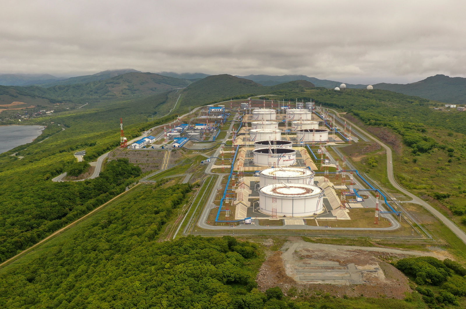 An aerial view shows oil tanks of Transneft oil pipeline operator at the crude oil terminal Kozmino on the shore of Nakhodka Bay near the port city of Nakhodka, Russia on June 13, 2022. Picture taken with a drone.