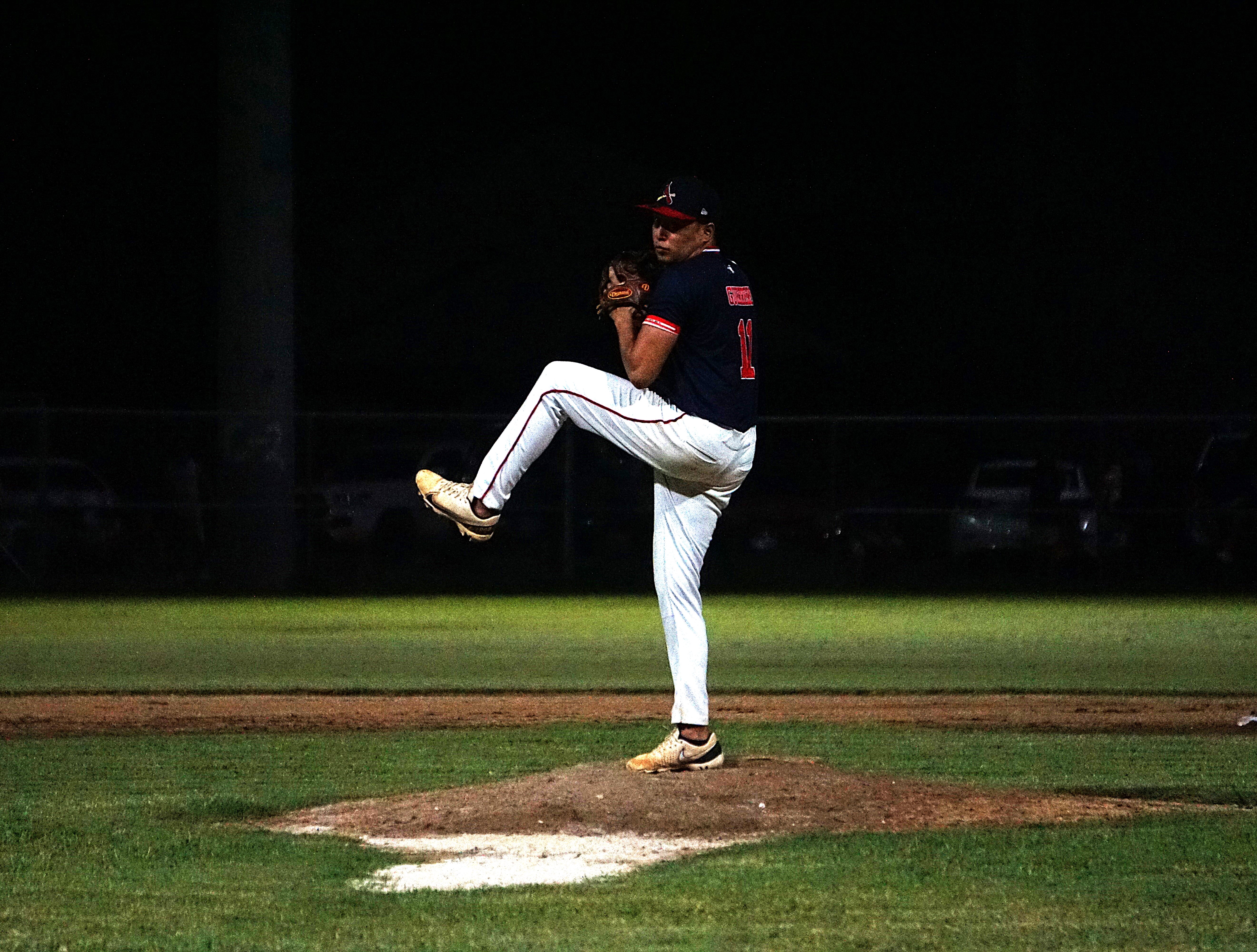 The Cardinals' Nate Guerrero winds up for the pitch against the Braves in the playoffs of the 2024 Tan Holdings Saipan Baseball League held at the Francisco "Tan Ko" Palacios Baseball Field.