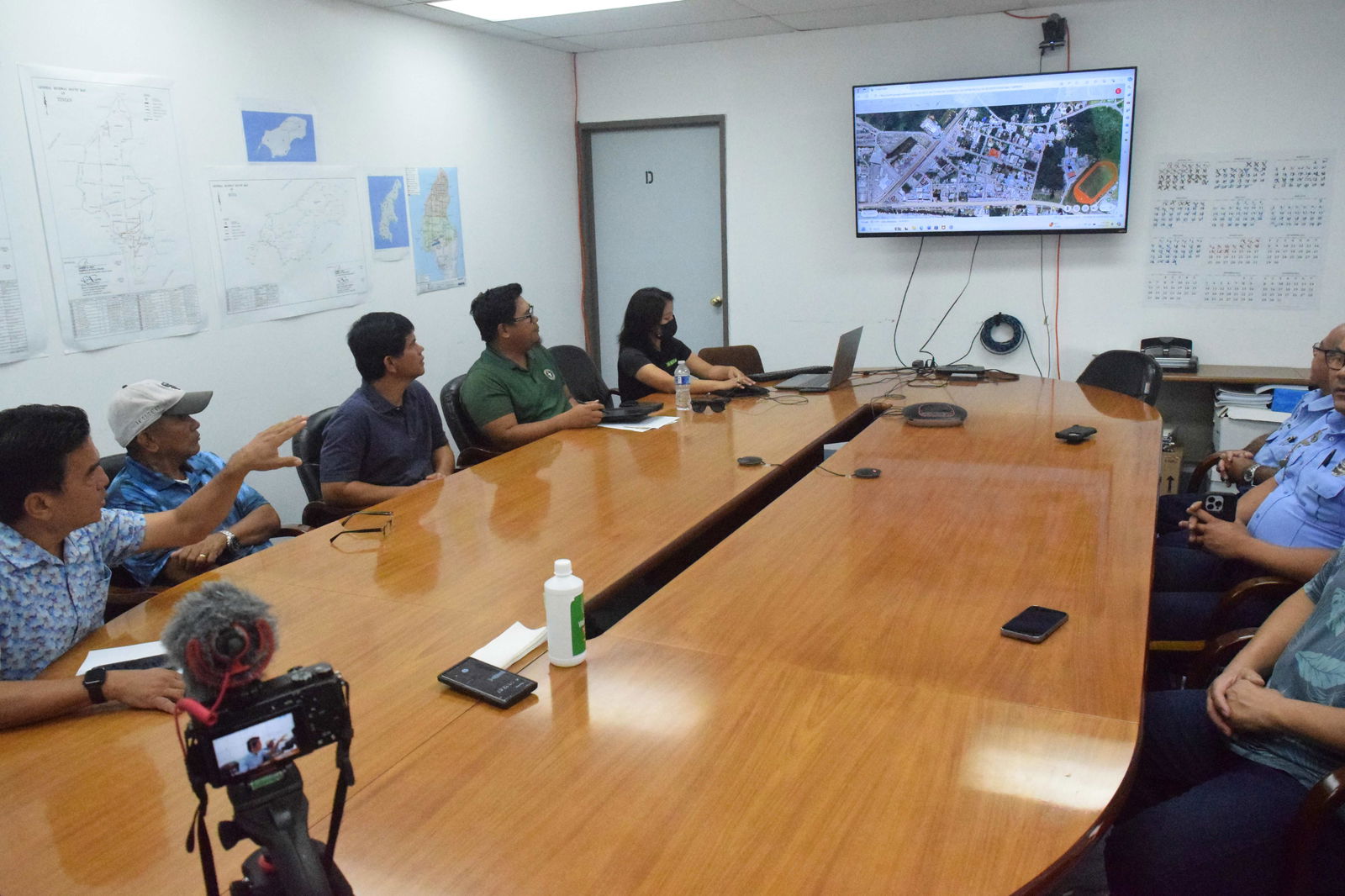 Department of Public Works Secretary Ray N. Yumul points to a map of San Jose during a meeting with officials of the Public School System, the Department of Public Safety and representatives of construction contractors in the conference room of the DPW Technical Services Division on Tuesday.