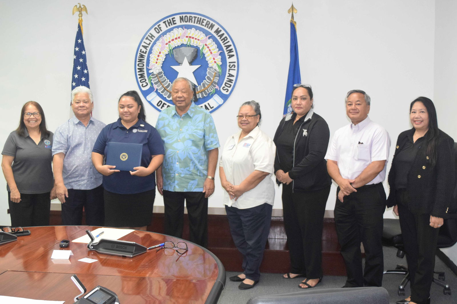 Office of Adult Probation supervisor Weena Gwendolyn Iguel, third left, holds her Patriot Award while she poses for a photo with ESGR Guan-CNMI Area Chair Rita A. Sablan, EdD, Gov. Arnold I. Palacios, Lt. Gov. David M. Apatang, Employer Outreach Coordinator Rose Igitol, ESGR State Ombudsman Joann T. Aquino, ESGR volunteer Tanya David and Civilian Aide to the U.S. Secretary of Army the Mike Sablan in the governor's conference room on Monday.