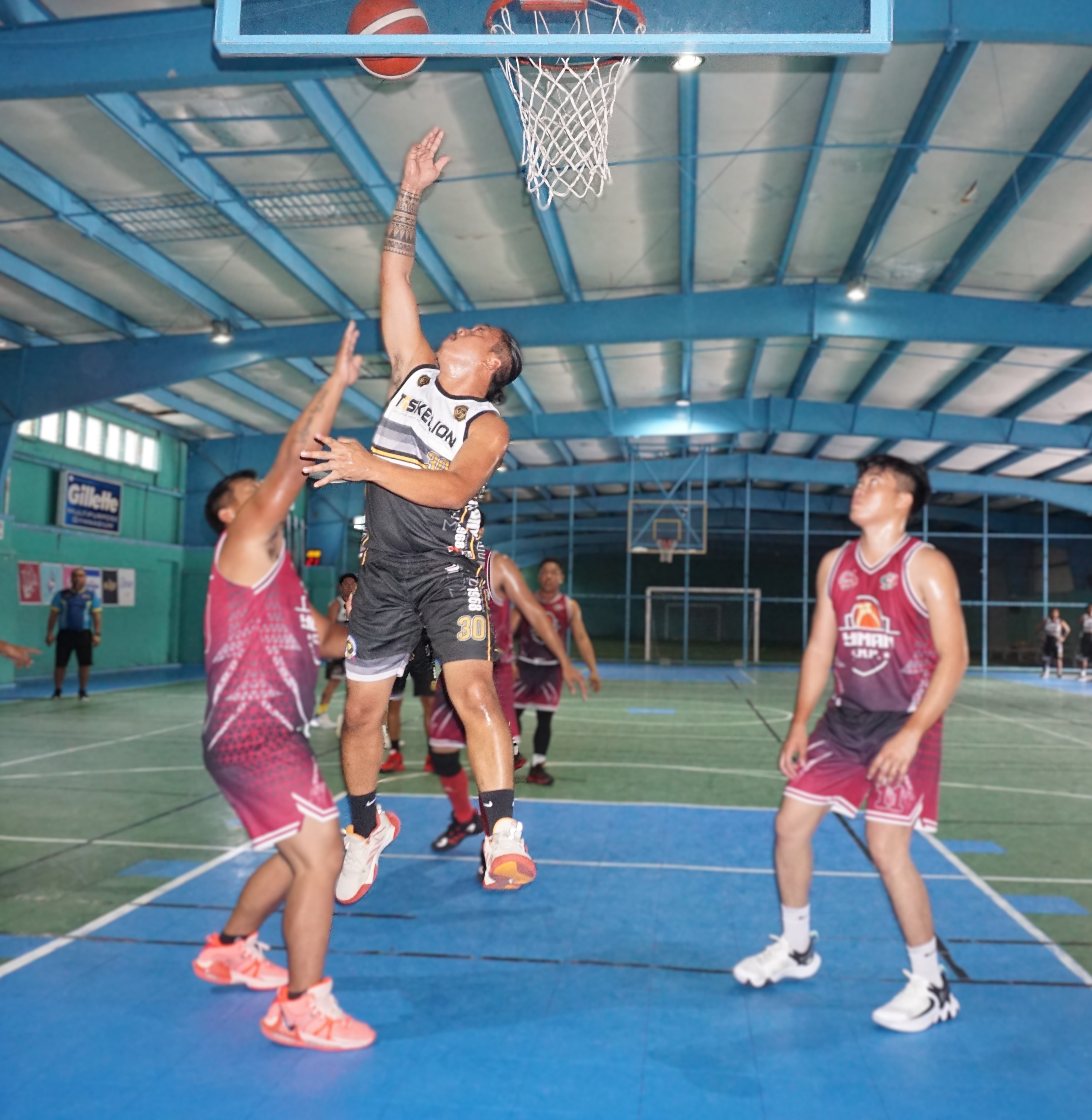 Triskelion's Aga Sapo takes off for the finish between two defenders during a game against GMP x Yuman in the Destroyers Basketball Club Invitational Basketball League 2024 at the TSL Sports Complex on Sunday.