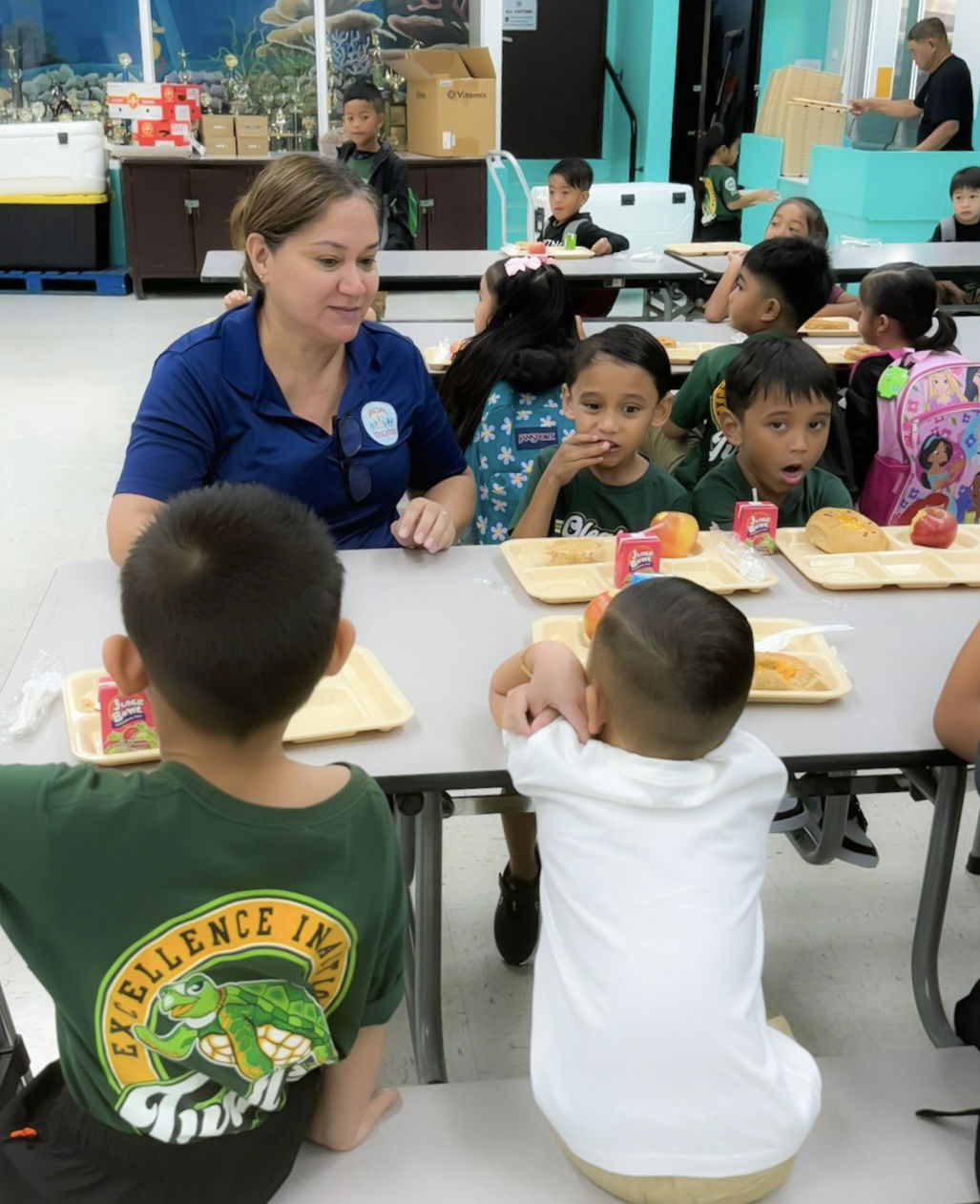 At Oleai Elementary School, Special Education Program State Director Donna M. Flores joins students during their breakfast in the school cafeteria.  Flores and other Public School System officials were at schools to assist in the opening of the new school year on Tuesday.