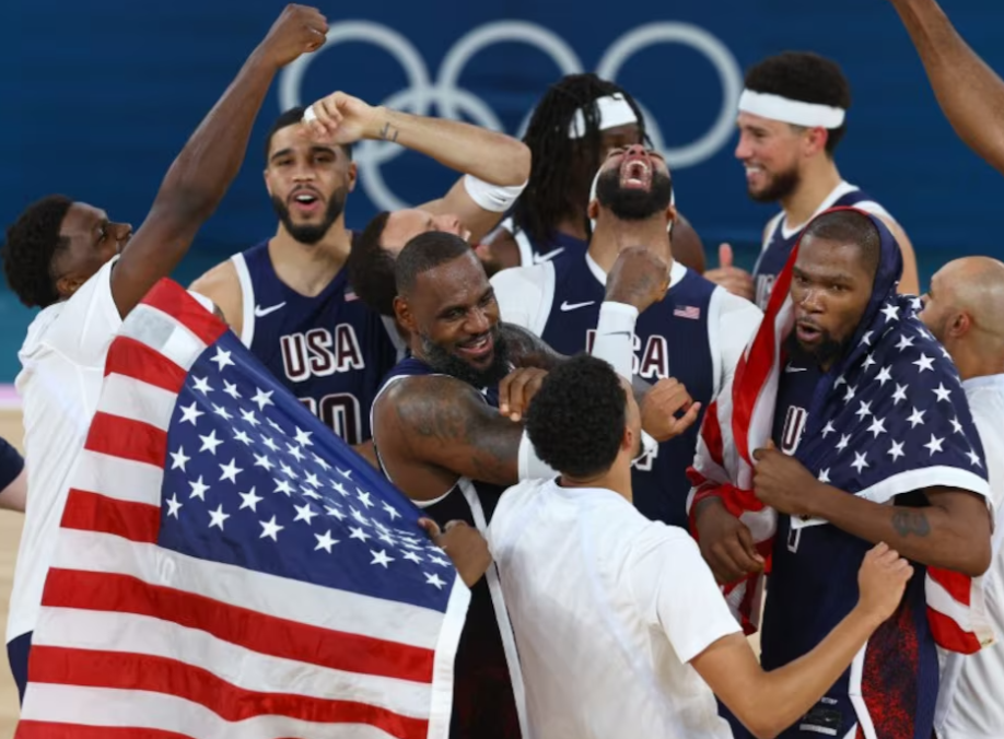 LeBron James of the United States celebrates with team mates after winning the gold medal game against France at the Bercy Arena in Paris, France on Aug. 10, 2024. 