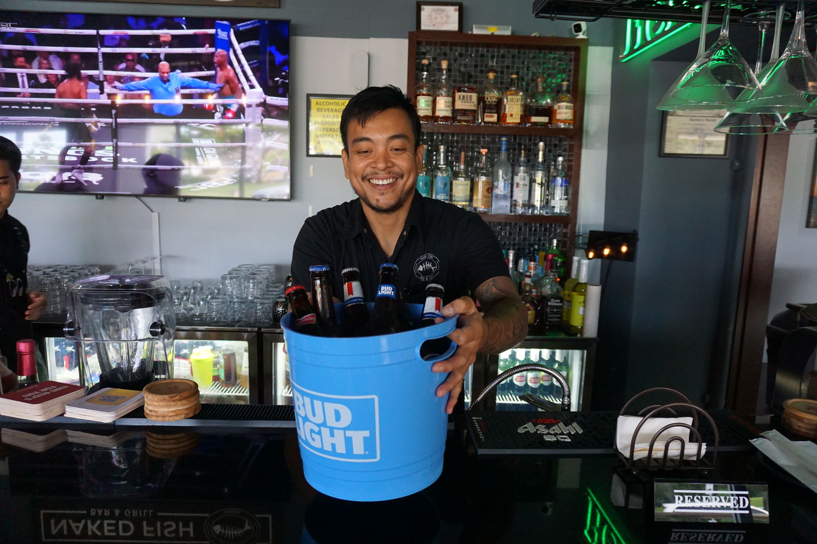 Jeff Mendoza serves up a bucket of Bud products at Naked Fish.