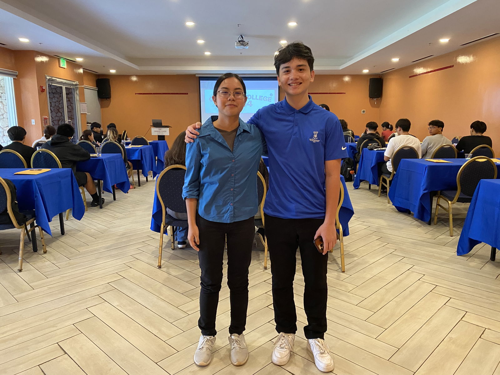 Yuri Sasamoto, left, and Jesse Sablan, pose for a photo before the start of a college application workshop they conducted earlier this month. The two are incoming sophomores at Columbia University.