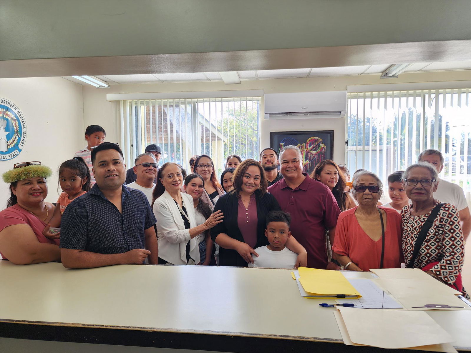 Precinct 1 independent House candidate Yvette Sablan, center, with her family members and other supporters at the Commonwealth Election Commission on Wednesday.
