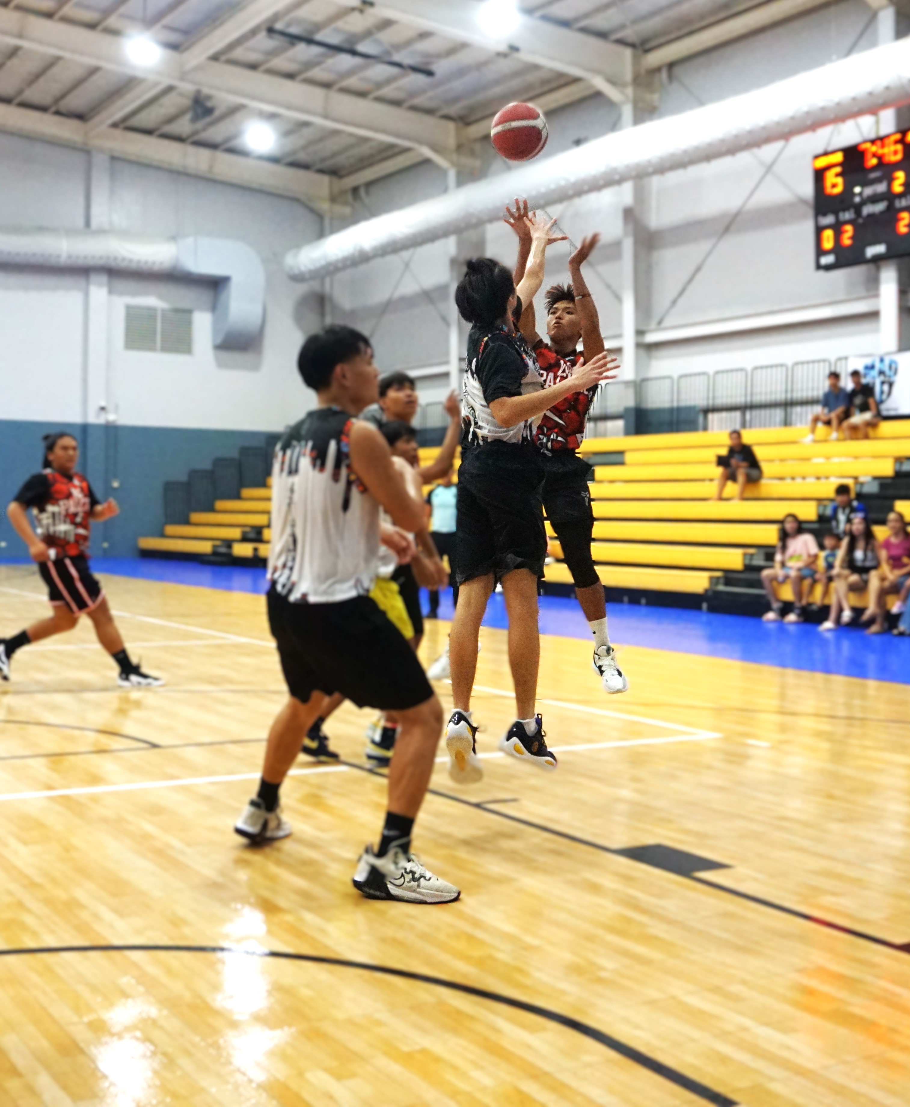 Win Pacific Corp's Webb Alano pulls up for the fadeaway jumper over a defender during a game against JTM Corp in season 1 of the Ali’i Madflex Sports Summer Youth Basketball Tournament 2024 at the Ada gym on Saturday.