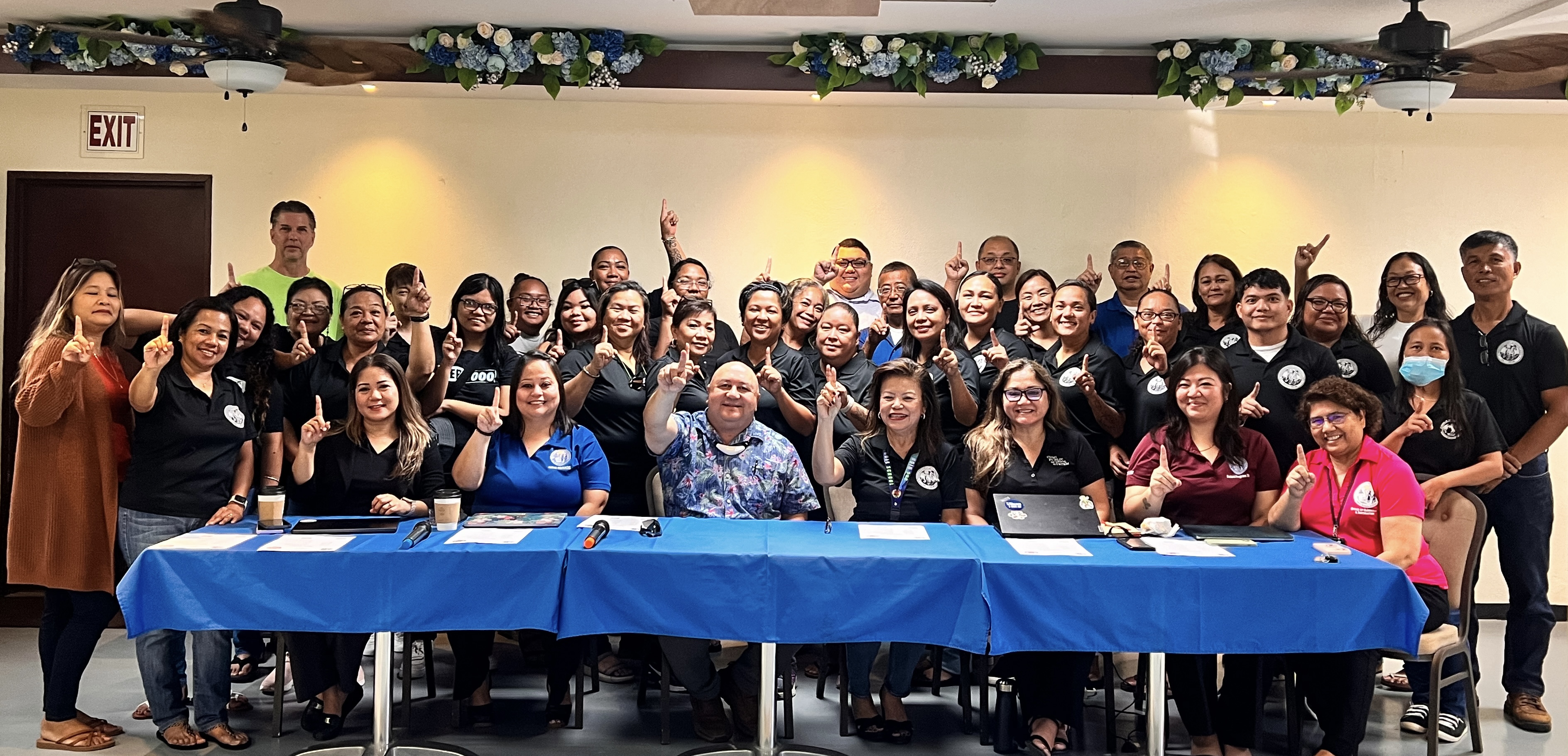 Tinian Middle School and High School instructional staff members led by Principal Liz Perzinski pose for a photo with Commissioner of Education Dr. Lawrence Camacho, seated center, Special Education State Director Donna Flores, Federal Programs Officer Jacqueline Che, Human Resources Officer Lucretia Deleon Guerrero, Finance and Procurement and Supply Director Arlene Lizama, Senior Director for Curriculum and Instruction Jackie Quitugua, and Instructional Technology and Distance Education Director Lorraine Catienza.