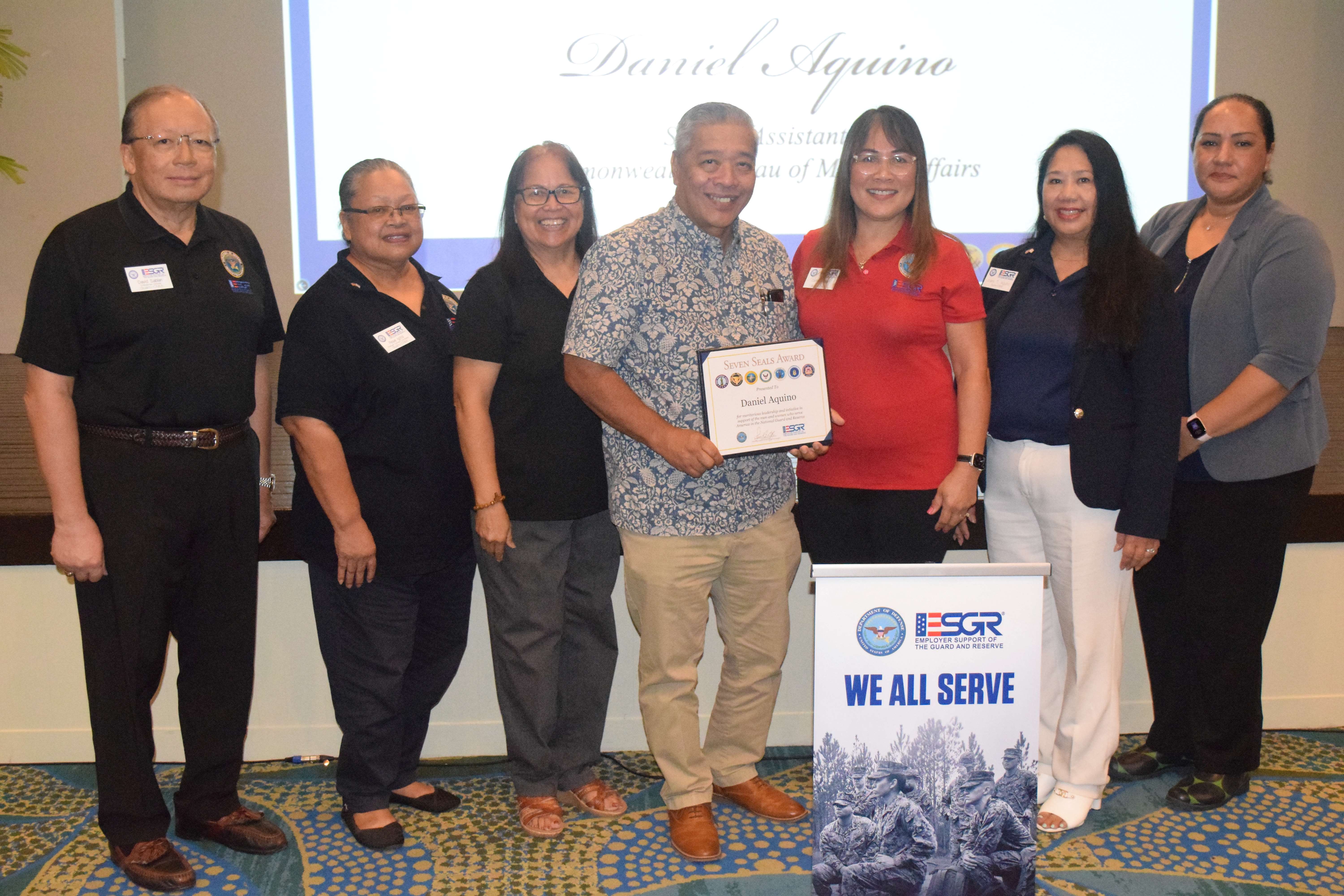 Special Assistant to the Governor for Military Affairs Danny Aquino, center, receives the Patriot Award from ESGR Guam-CNMI State Chair Cathy Gogue. Also in photo are Ombudsman Director Dave Sablan Jr., Employer Outreach Coordinator Rose Igitol, Area Chair Dr. Rita A. Sablan, Ombudsman Joann Aquino, and volunteer Tanya David.