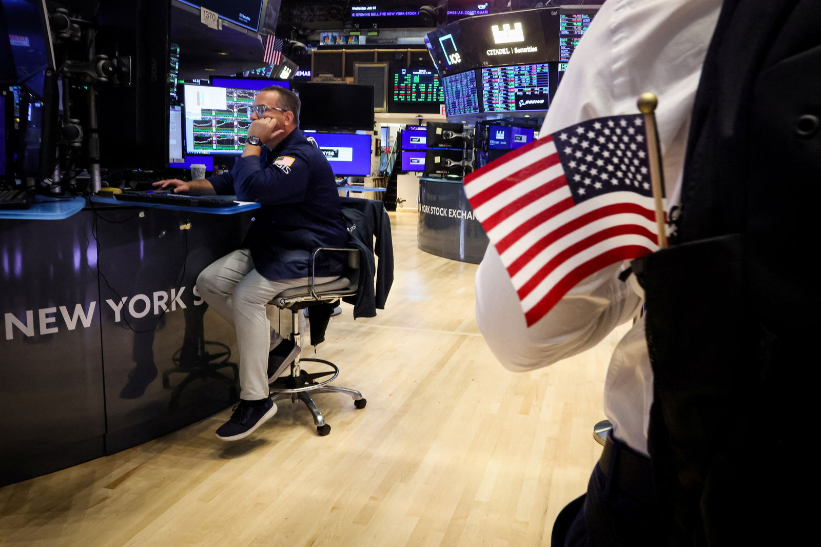 Traders work on the floor at the New York Stock Exchange in New York City, July 3, 2024.